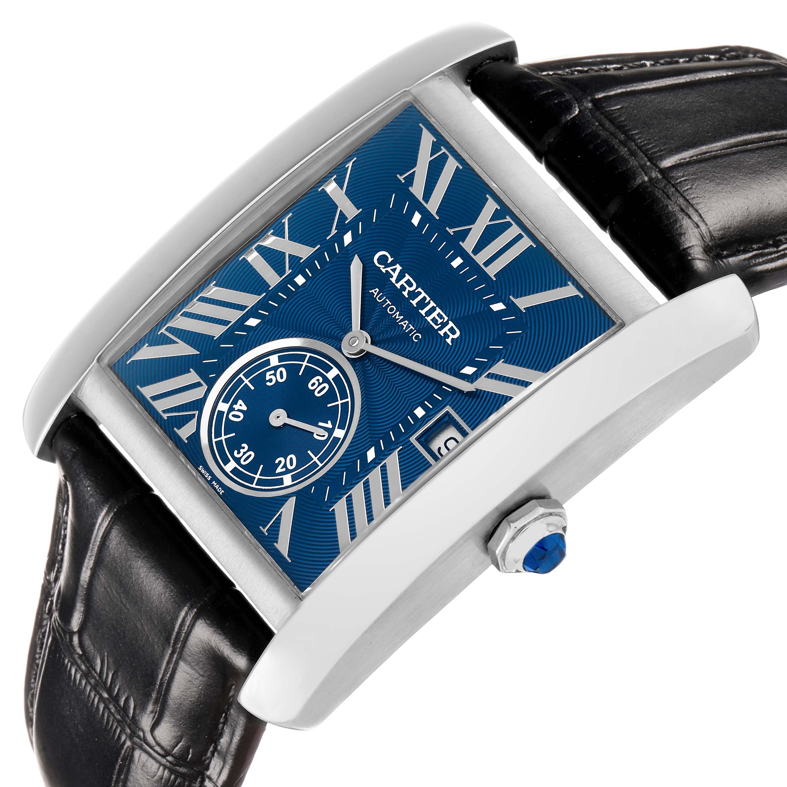 The Cartier Tank MC WSTA0010 Men's Stainless Steel Blue Dial watch is shown at an angled close-up, highlighting its blue dial, Roman numerals, sub-dial, and leather strap.