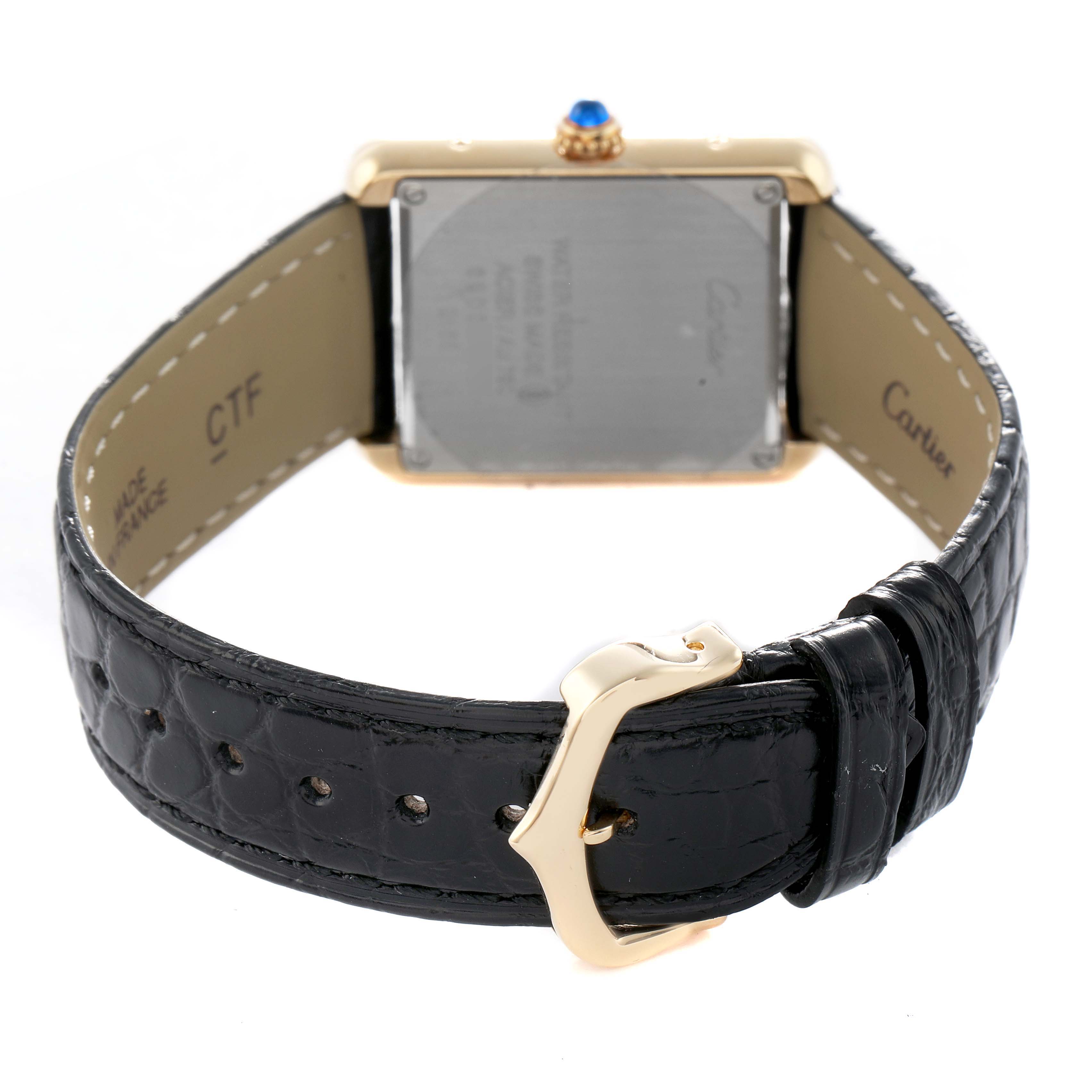 The Cartier Tank Solo W5200002 Women's Steel and Gold (two tone) Silver Dial watch is shown from the back, highlighting the case, strap, and buckle.