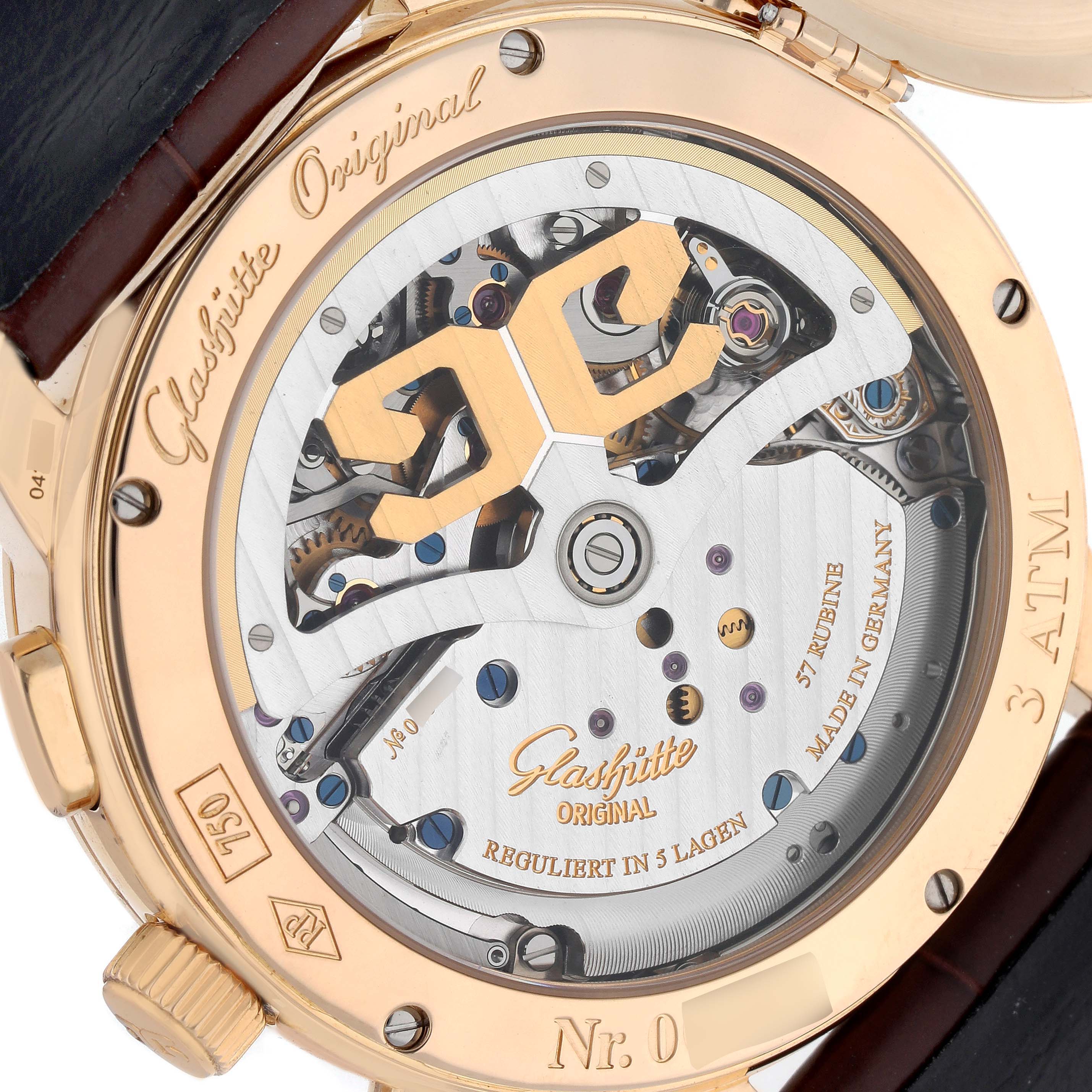 The image shows the back view of a Glashütte Original watch, highlighting its mechanical movement and engraved details.
