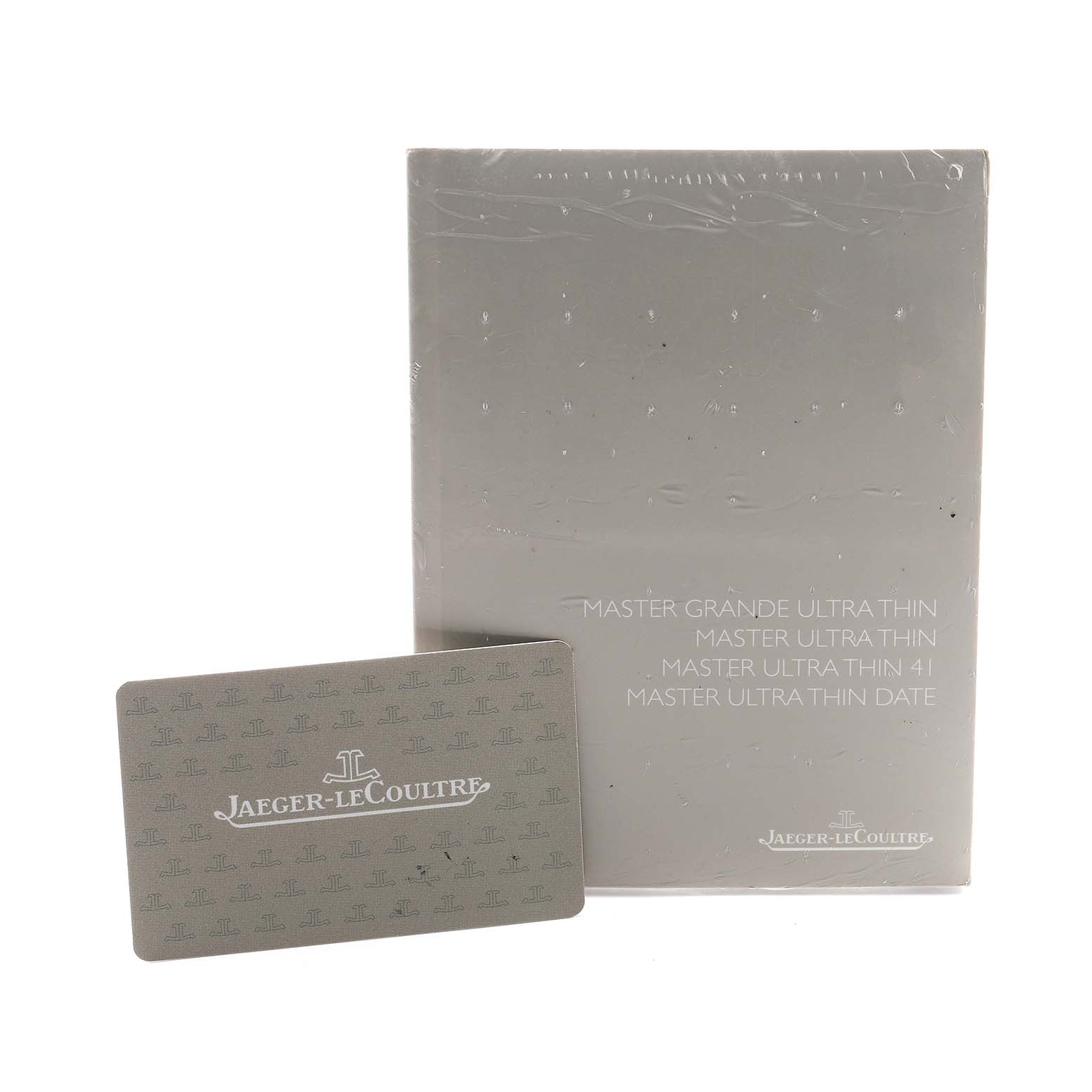 The image shows the packaging and instruction booklet for the Jaeger LeCoultre Master Q1368470 Men's Stainless Steel Black Dial model, alongside a branded card.