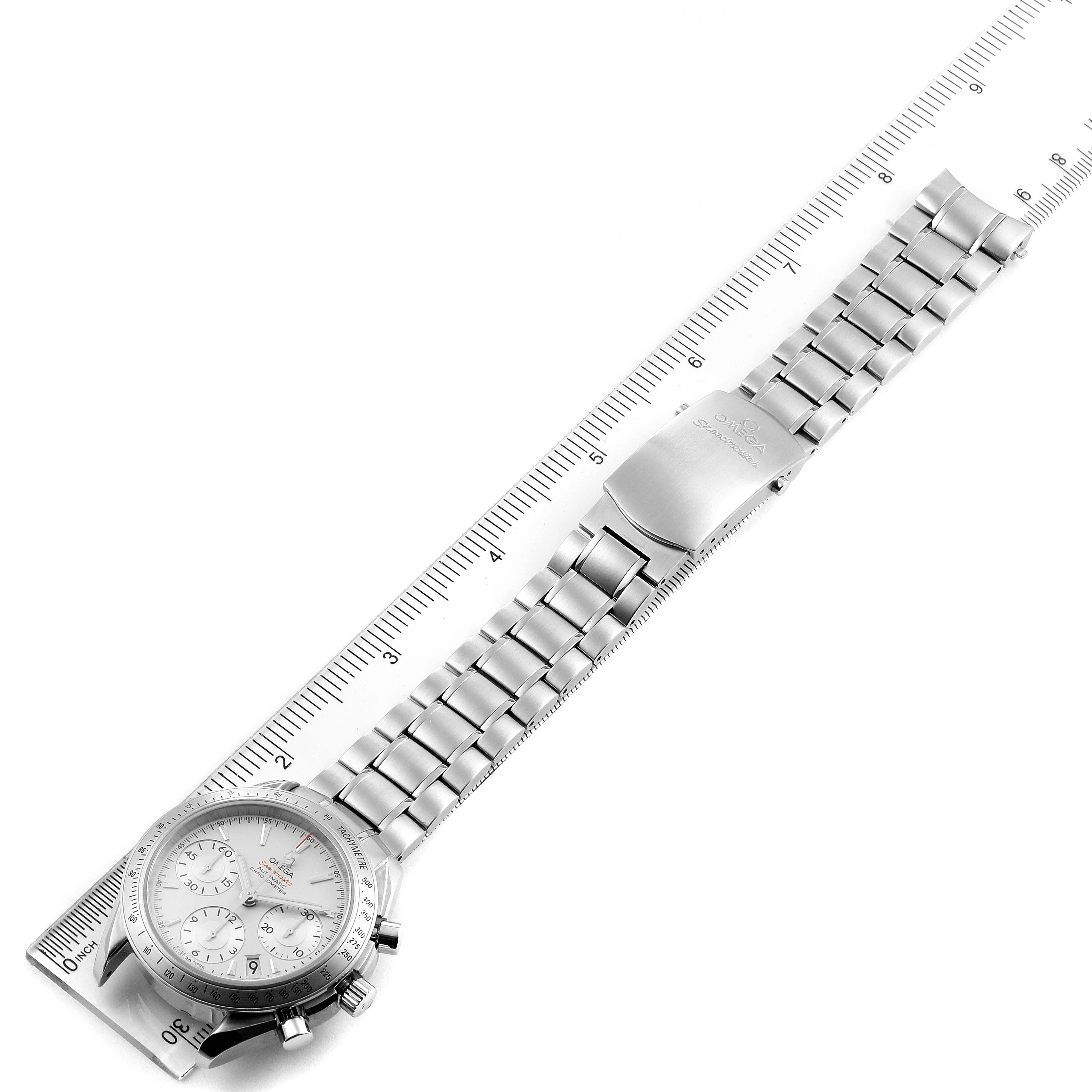 The Omega Speedmaster 323.10.40.40.02.001 Men
s Stainless Steel Silver Dial 323.10.40.40.02.001 Men
s Stainless Steel Silver Dial watch is shown from a top-down angle, displaying the bracelet and clasp alongside a ruler.