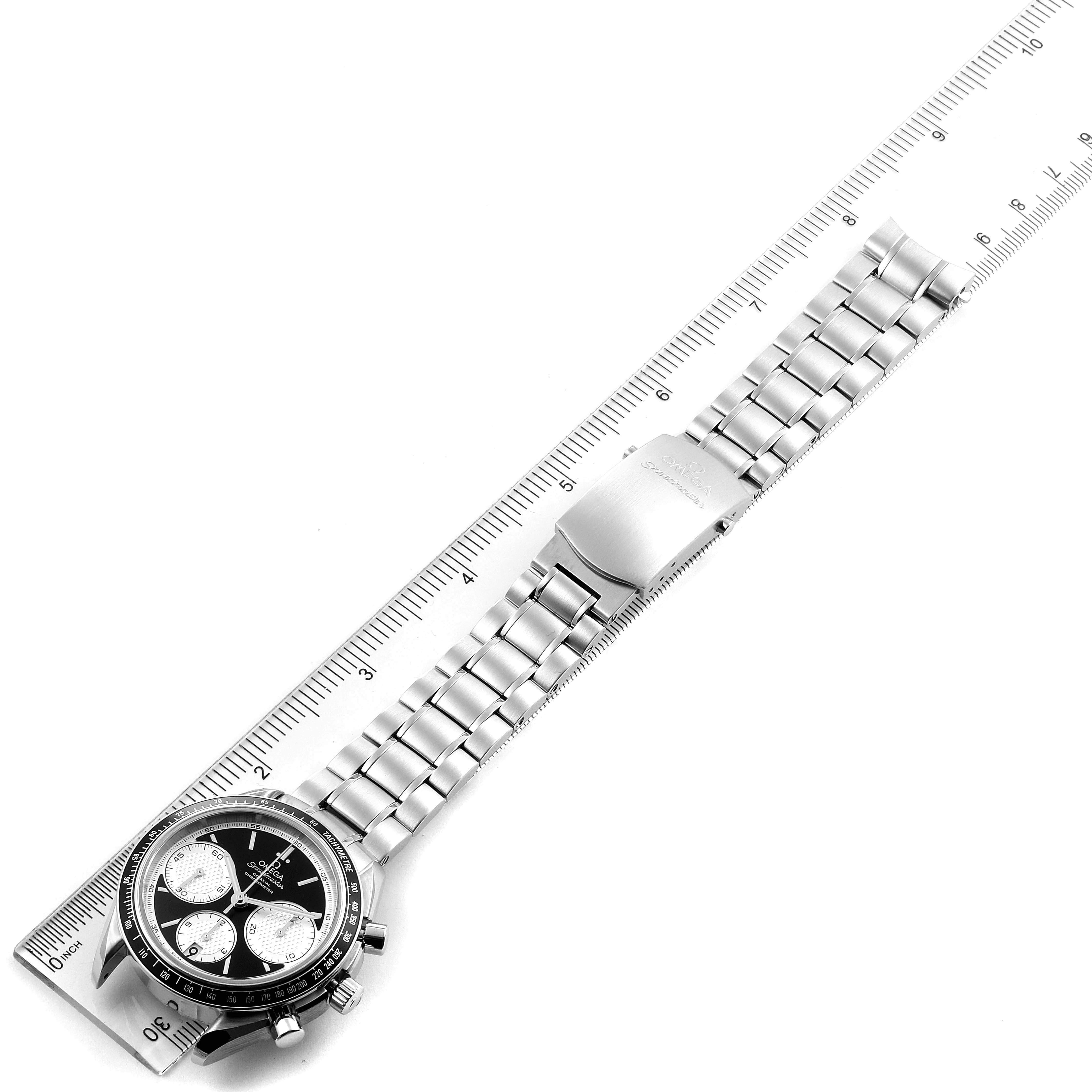 The Omega Speedmaster 326.30.40.50.01.002 Men
s Stainless Steel Black Dial 326.30.40.50.01.002 Men
s Stainless Steel Black Dial watch is displayed flat with its bracelet aligned against a ruler for scale.