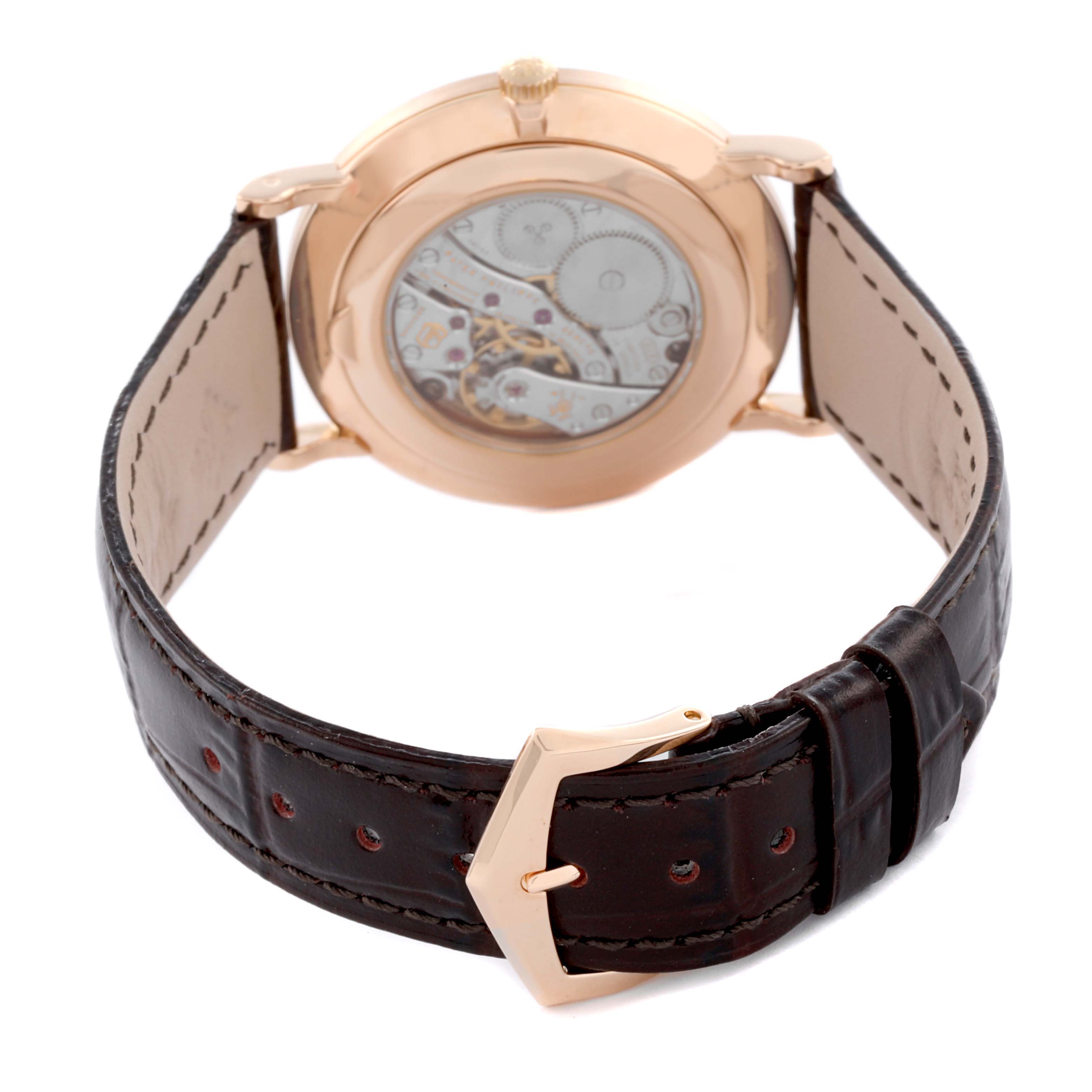 The image shows the back of the Patek Philippe Calatrava 5119R-001 Men's Rose Gold White Dial 5119R-001 Men's Rose Gold White Dial watch, highlighting its open case back and leather strap.