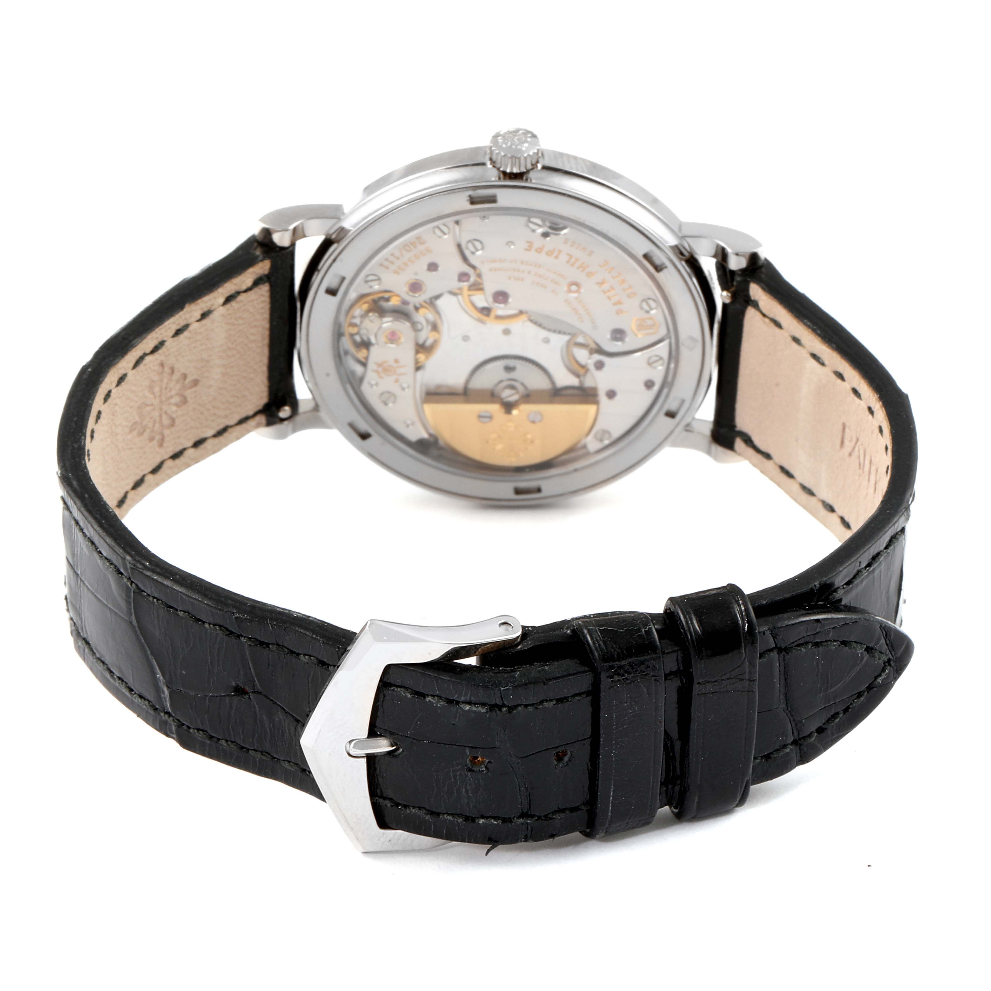 The Patek Philippe Calatrava 5120G Men's White Gold White Dial 5120G Men's White Gold White Dial watch is shown from the rear, displaying the movement and leather strap with a buckle.