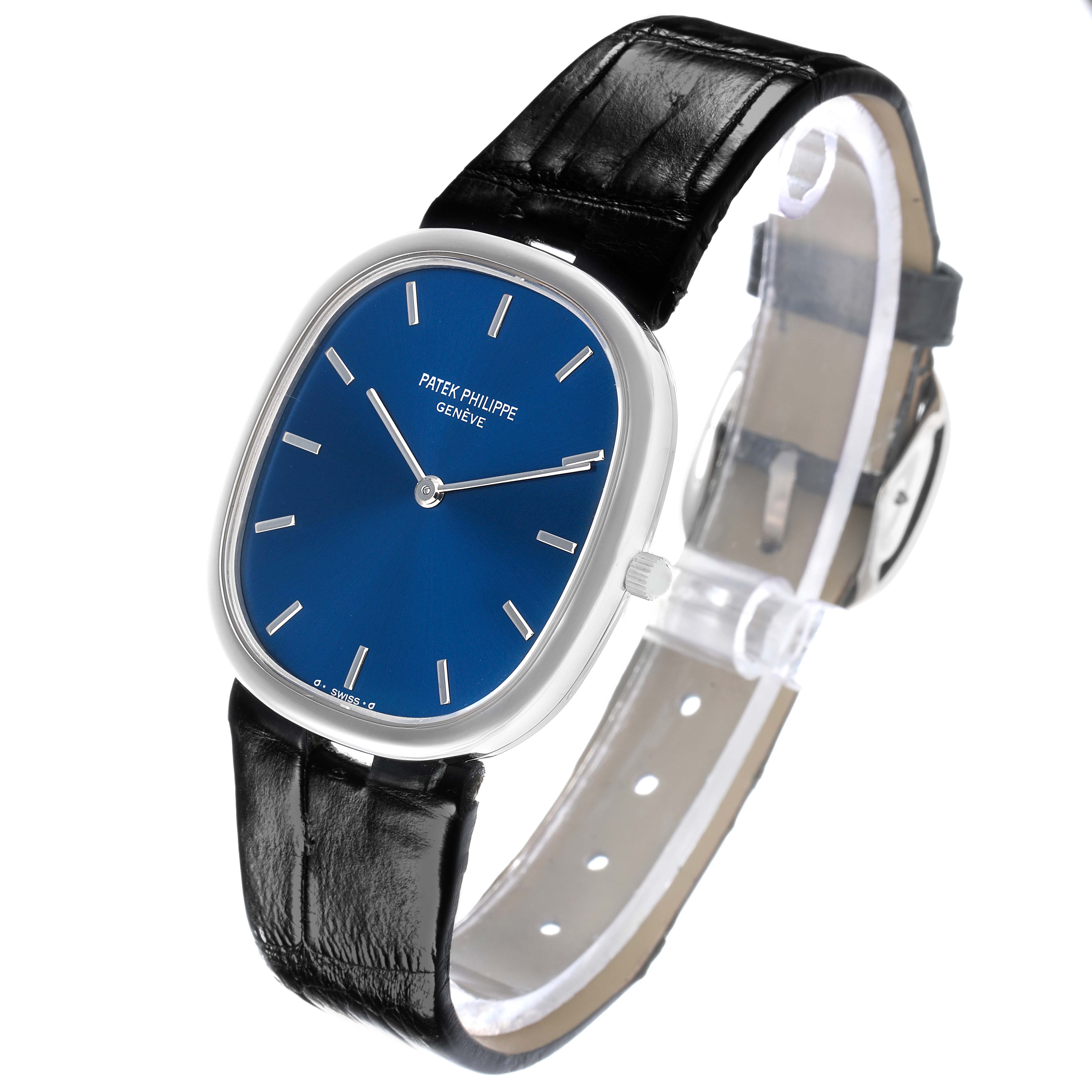 The Patek Philippe Golden Ellipse 3738 Men's White Gold Blue Dial is shown at an angle highlighting the blue dial, silver markers, and black leather strap.