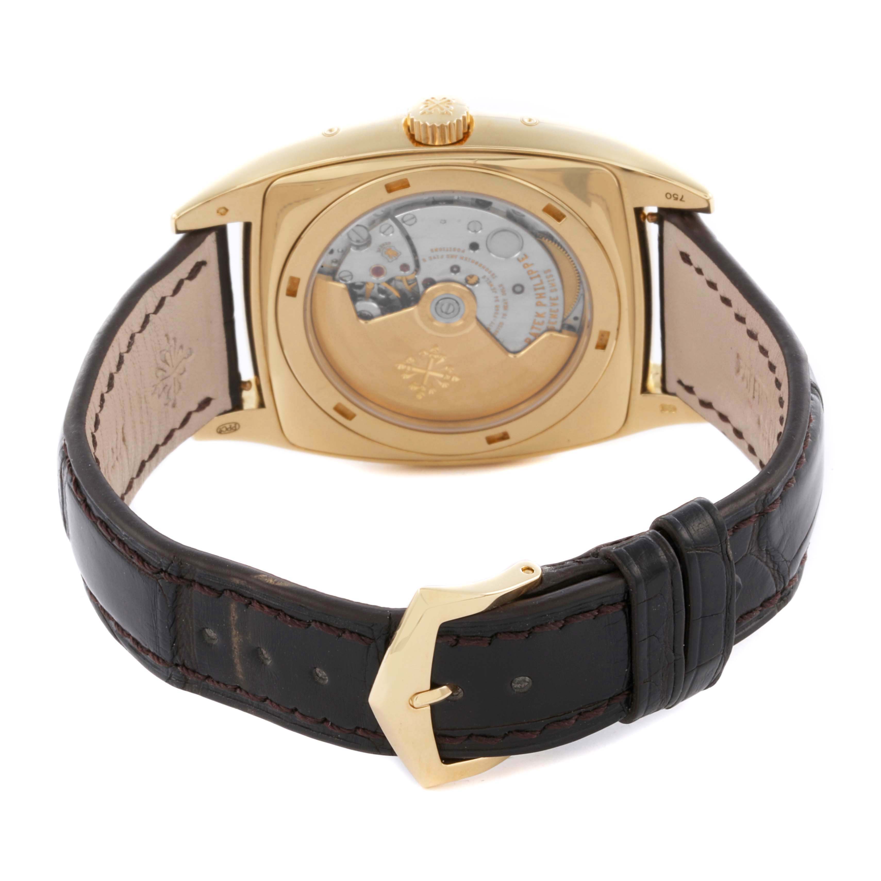 The Patek Philippe Gondolo 5135J-001 Men's Yellow Gold Silver Dial 5135J-001 Men's Yellow Gold Silver Dial watch is shown from the back, displaying the movement and leather strap with a gold buckle.