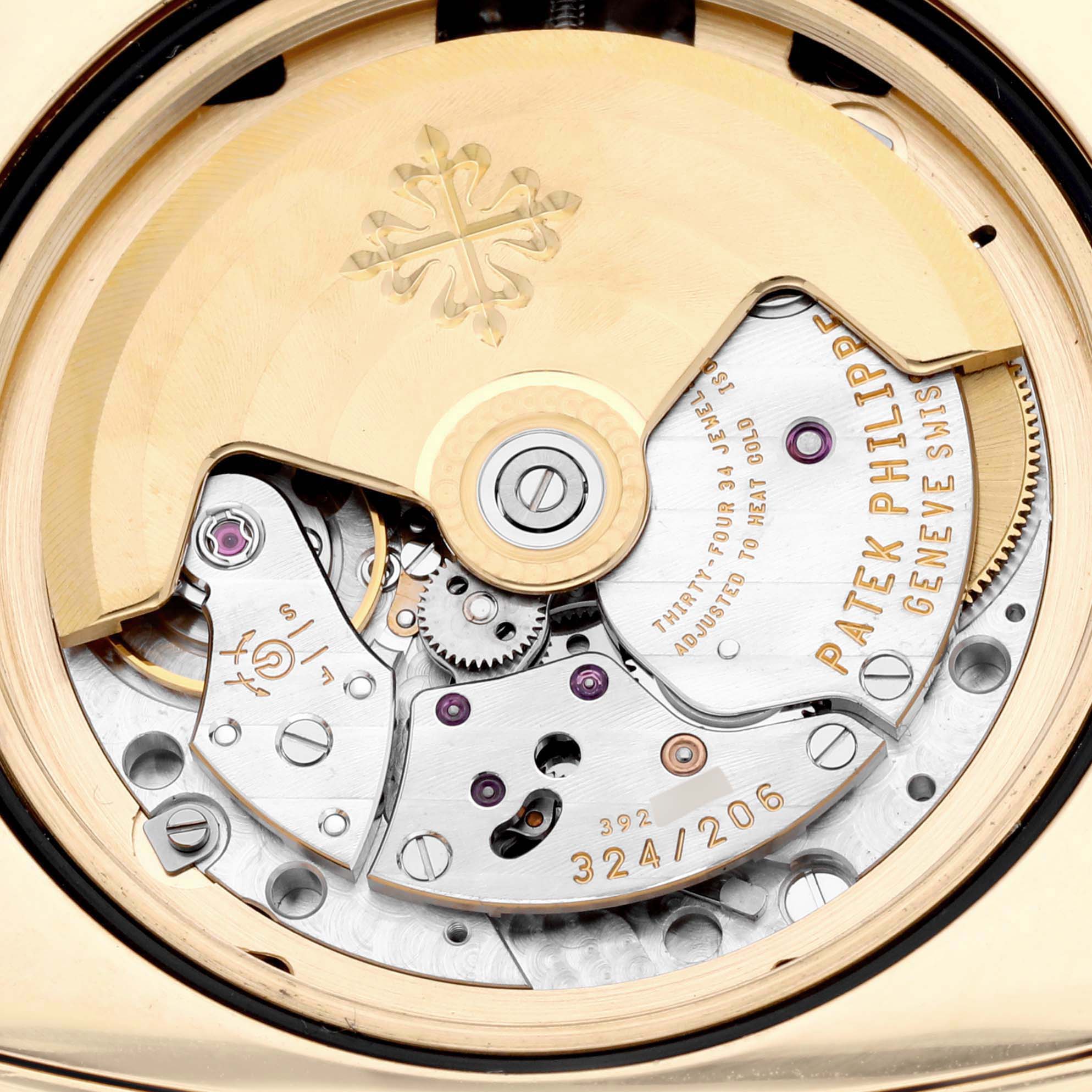 The image shows the back movement of the Patek Philippe Gondolo 5135J-001 Men's Yellow Gold Silver Dial 5135J-001 Men's Yellow Gold Silver Dial, highlighting mechanical components and engravings.