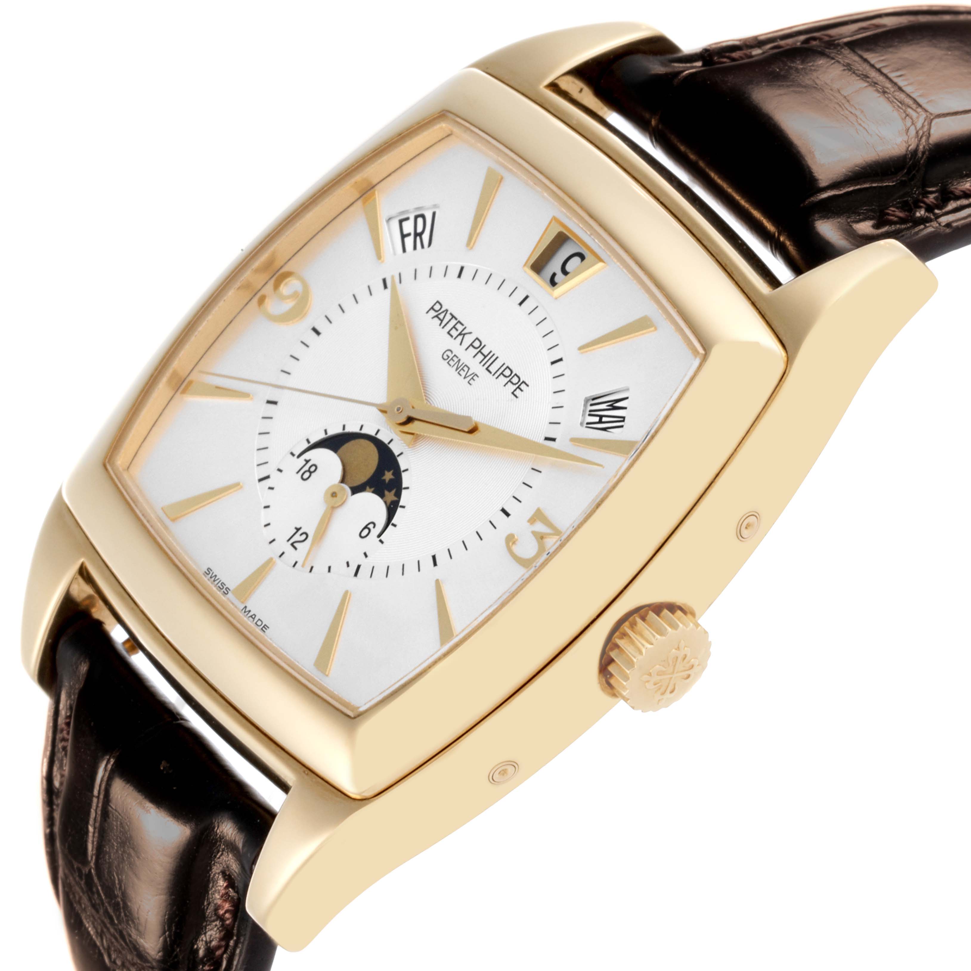 The Patek Philippe Gondolo 5135J-001 Men's Yellow Gold Silver Dial 5135J-001 Men's Yellow Gold Silver Dial watch is shown at a slight side angle, highlighting the rectangular dial, moon phase, and crown with a leather strap.