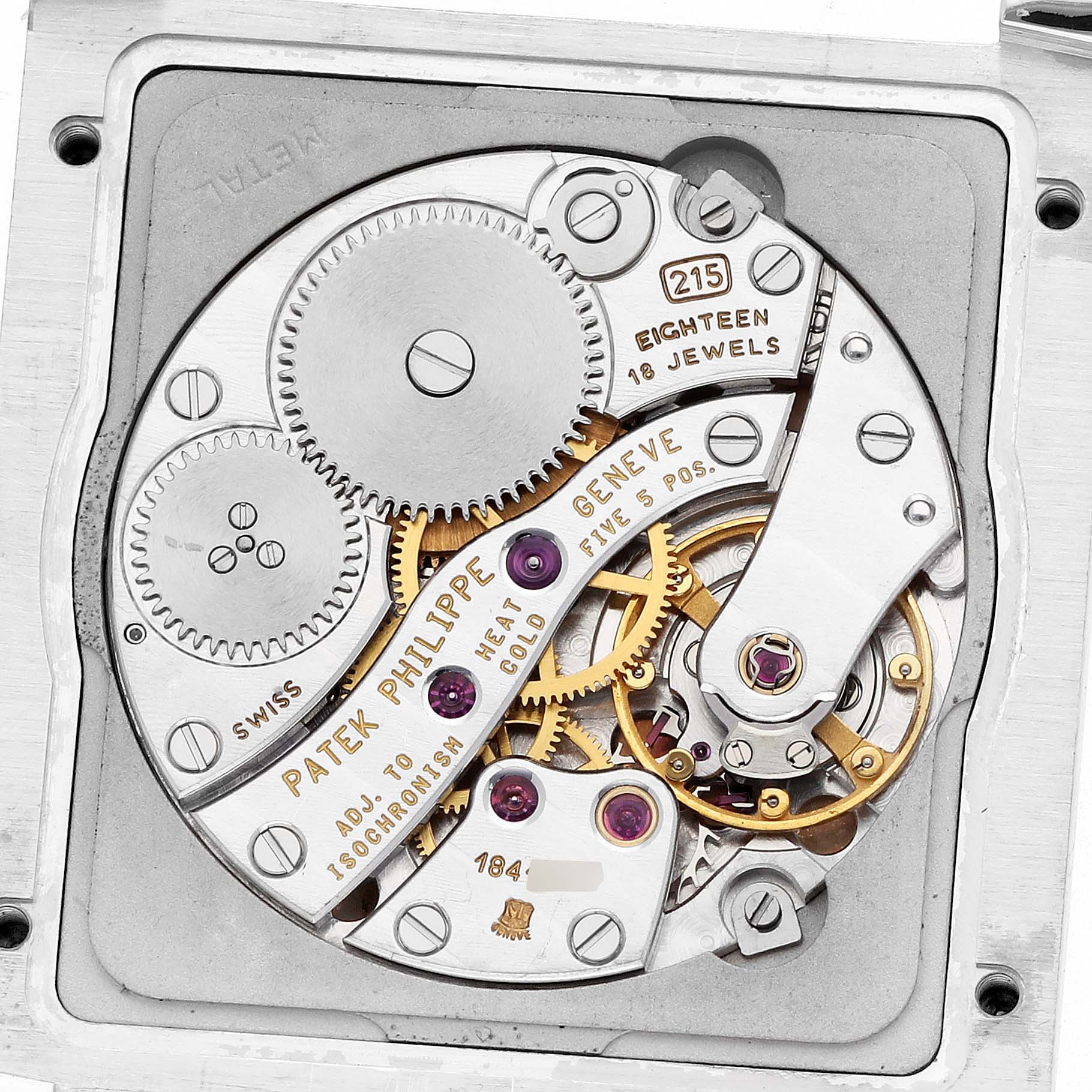 The image shows the movement of a Patek Philippe Gondolo 5014 Men's White Gold Silver Dial watch from a top-down angle, highlighting gears and jewel details.
