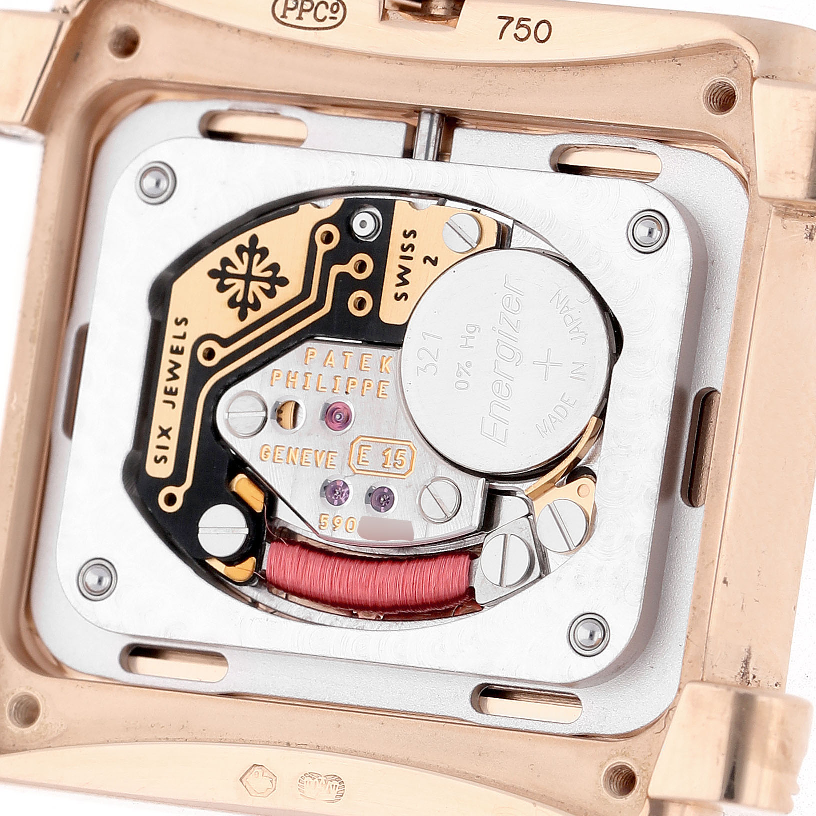 The image shows the back view of the Patek Philippe Twenty-4 4910 Women's Rose Gold Brown Dial watch, highlighting its movement and battery compartment.