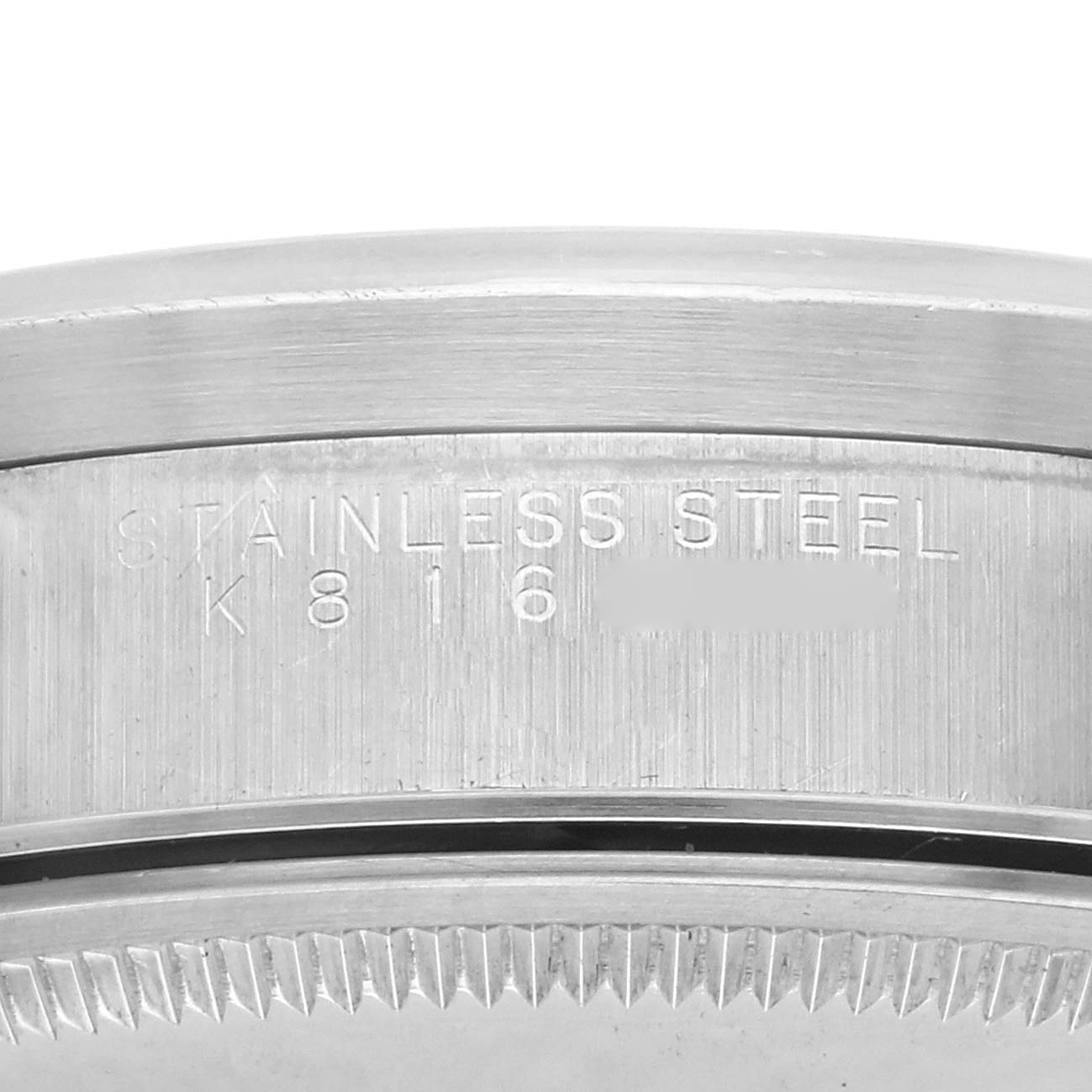 The image shows a close-up side view of the stainless steel bezel of a Rolex Air-King 14010M Men's Stainless Steel Blue Dial 14010M Men's Stainless Steel Blue Dial watch.