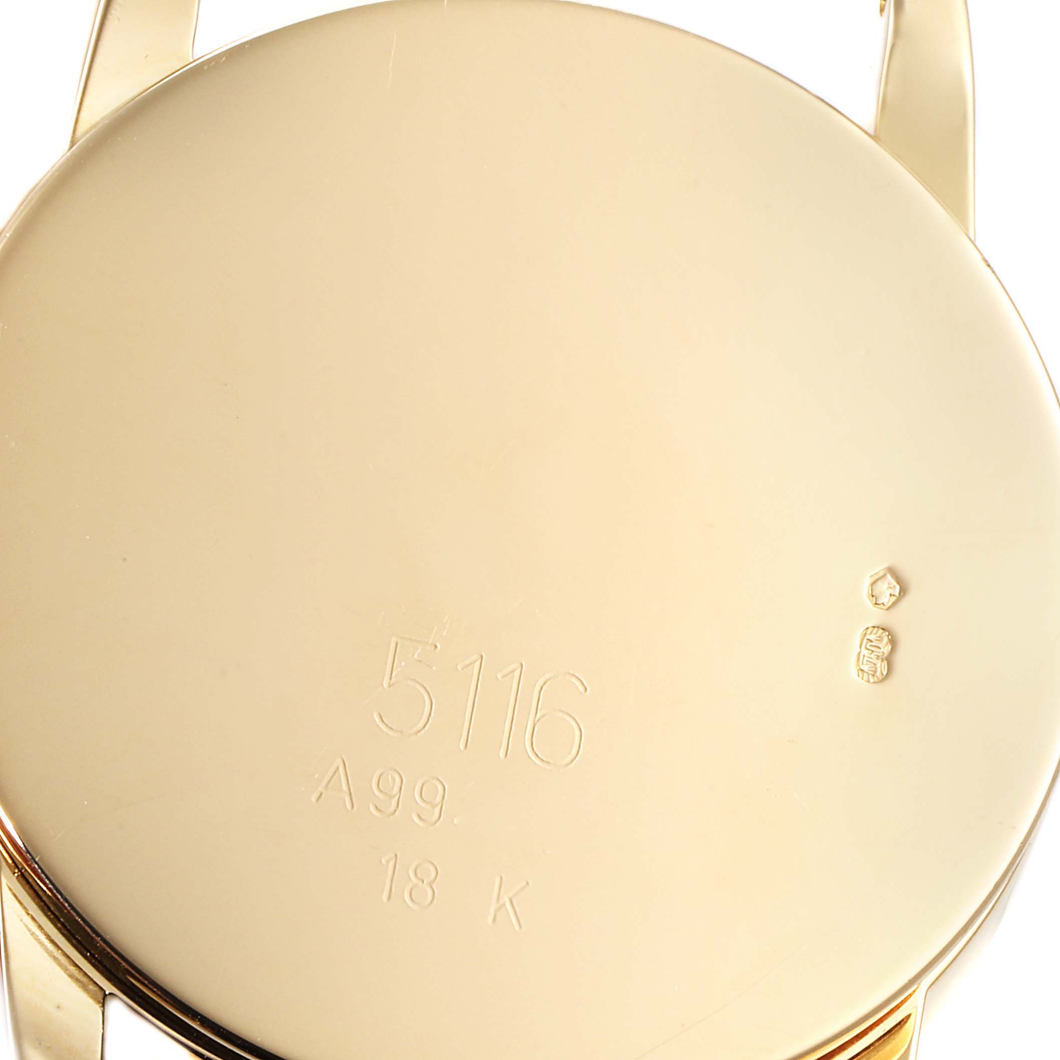 This image shows the back casing of a Rolex Cellini 5116 Men's Yellow Gold Mother of Pearl Dial 5116 Men's Yellow Gold Mother of Pearl Dial model watch, displaying the engravings and hallmarks.