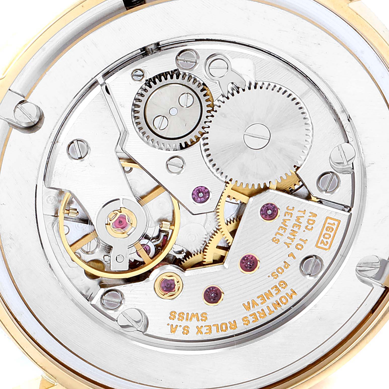 The image shows the internal mechanism of a Rolex Cellini 5116 Men's Yellow Gold Mother of Pearl Dial 5116 Men's Yellow Gold Mother of Pearl Dial watch from a rear angle, highlighting gears and jewels.