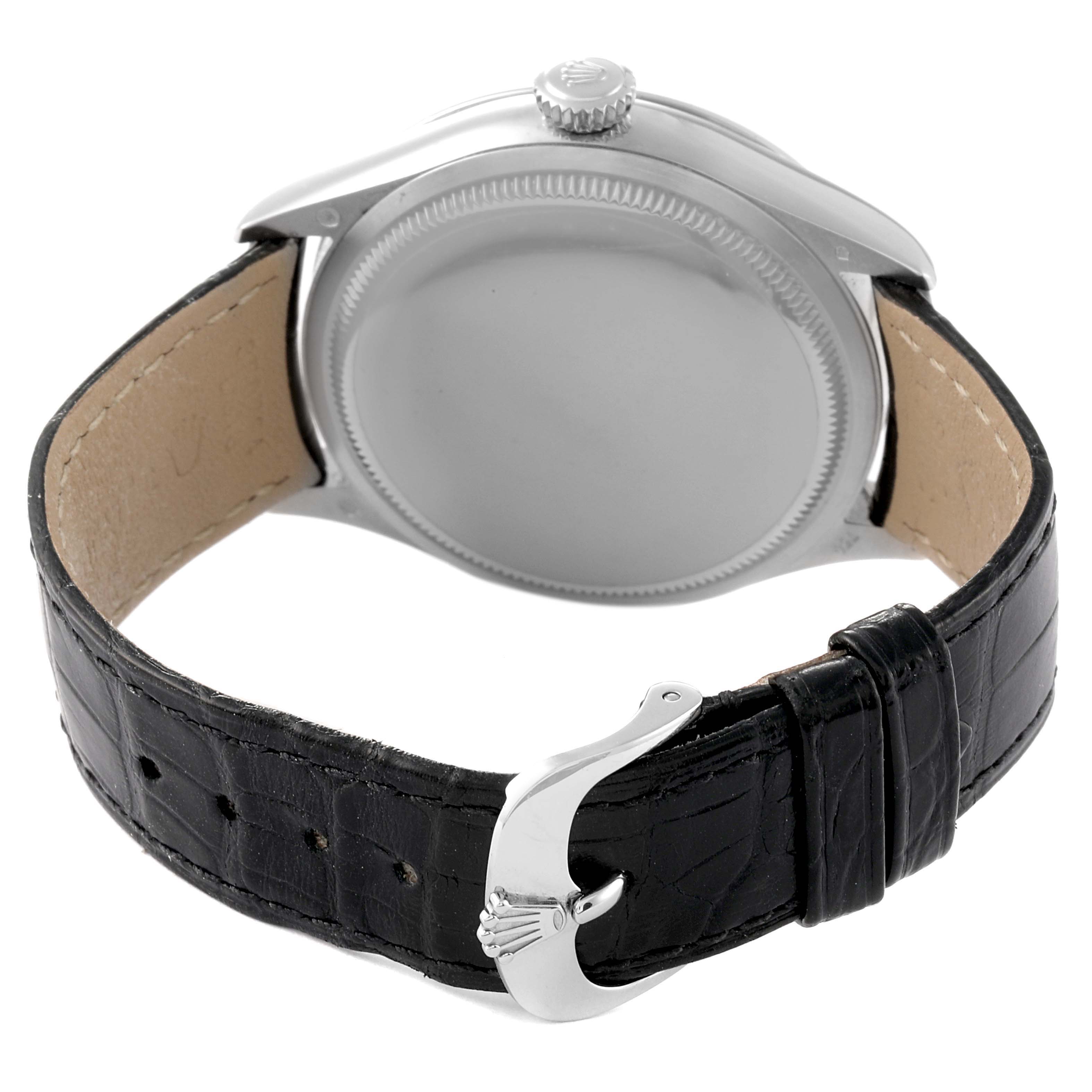 This image shows the back view of a Rolex Cellini 50709 Men's White Gold Silver Dial 50709 Men's White Gold Silver Dial watch, highlighting the case, crown, and black leather strap with the clasp.