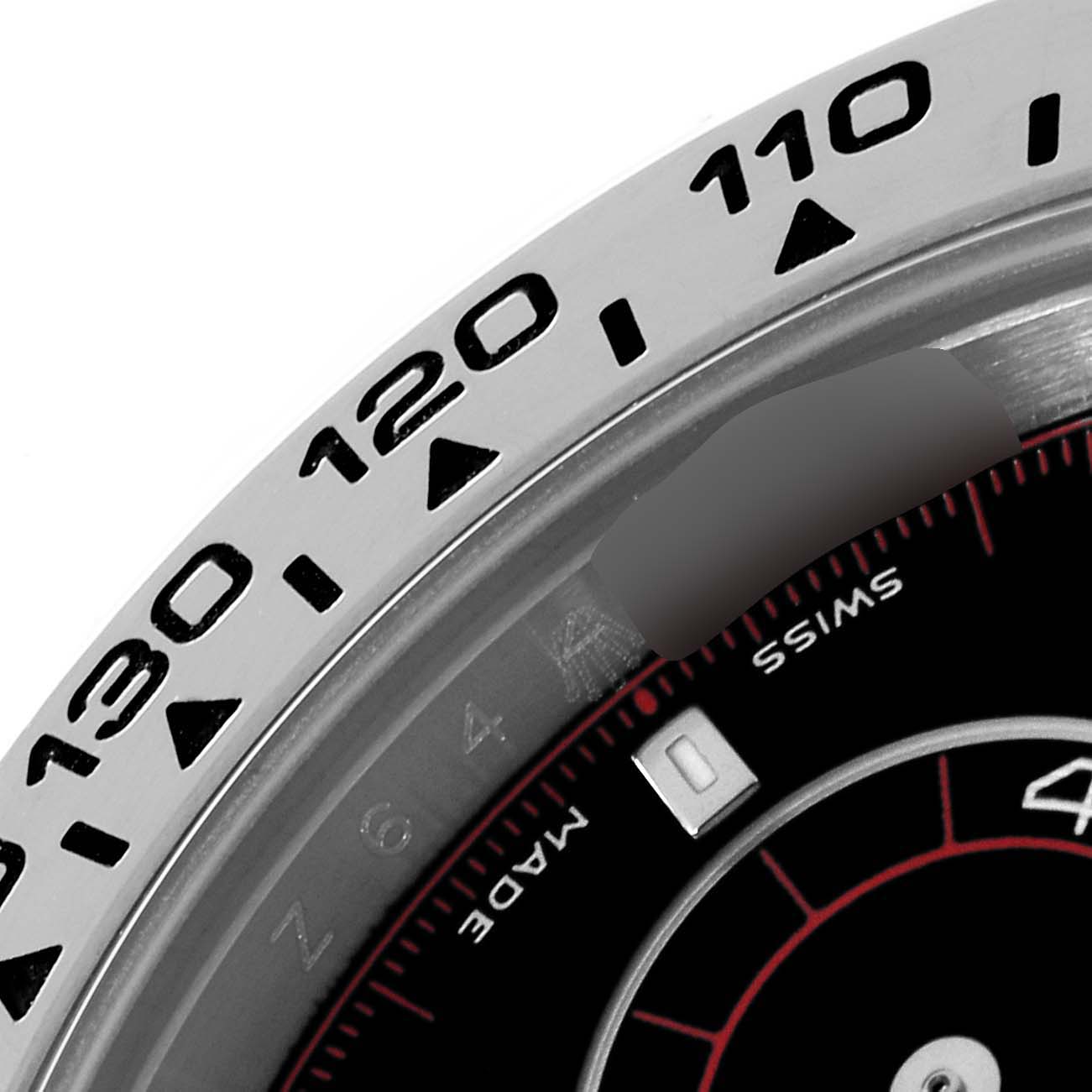 This is a close-up of the bezel and dial of a Rolex Daytona 116509 Men's White Gold Black Dial 116509 Men's White Gold Black Dial watch, focusing on the tachymeter scale and a portion of the dial.