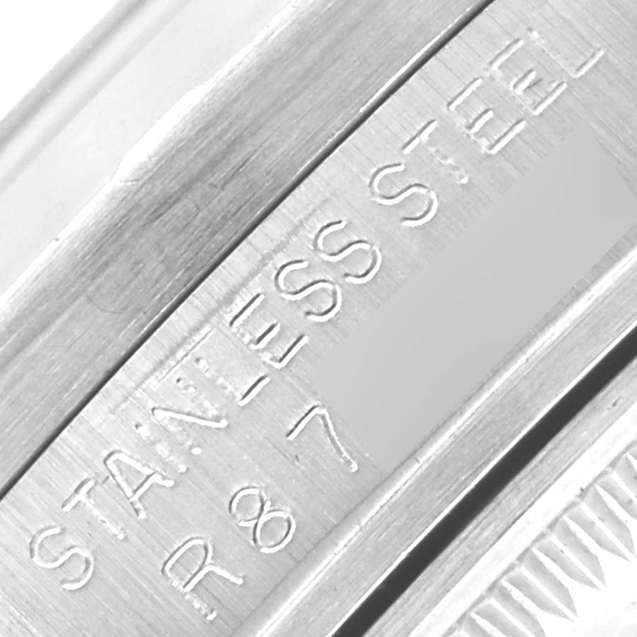 The image shows a close-up of the stainless steel case side of the Rolex Vintage Collection 15010 Men's Stainless Steel Silver Dial 15010 Men's Stainless Steel Silver Dial watch with engraved details.