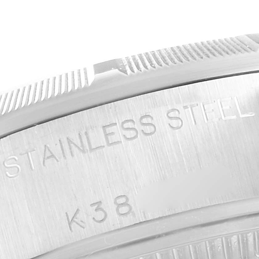 Close-up of the side of a Rolex Date 79190 Women's Stainless Steel White Dial 79190 Women's Stainless Steel White Dial model, showing the stainless steel engraving and part of the bezel.