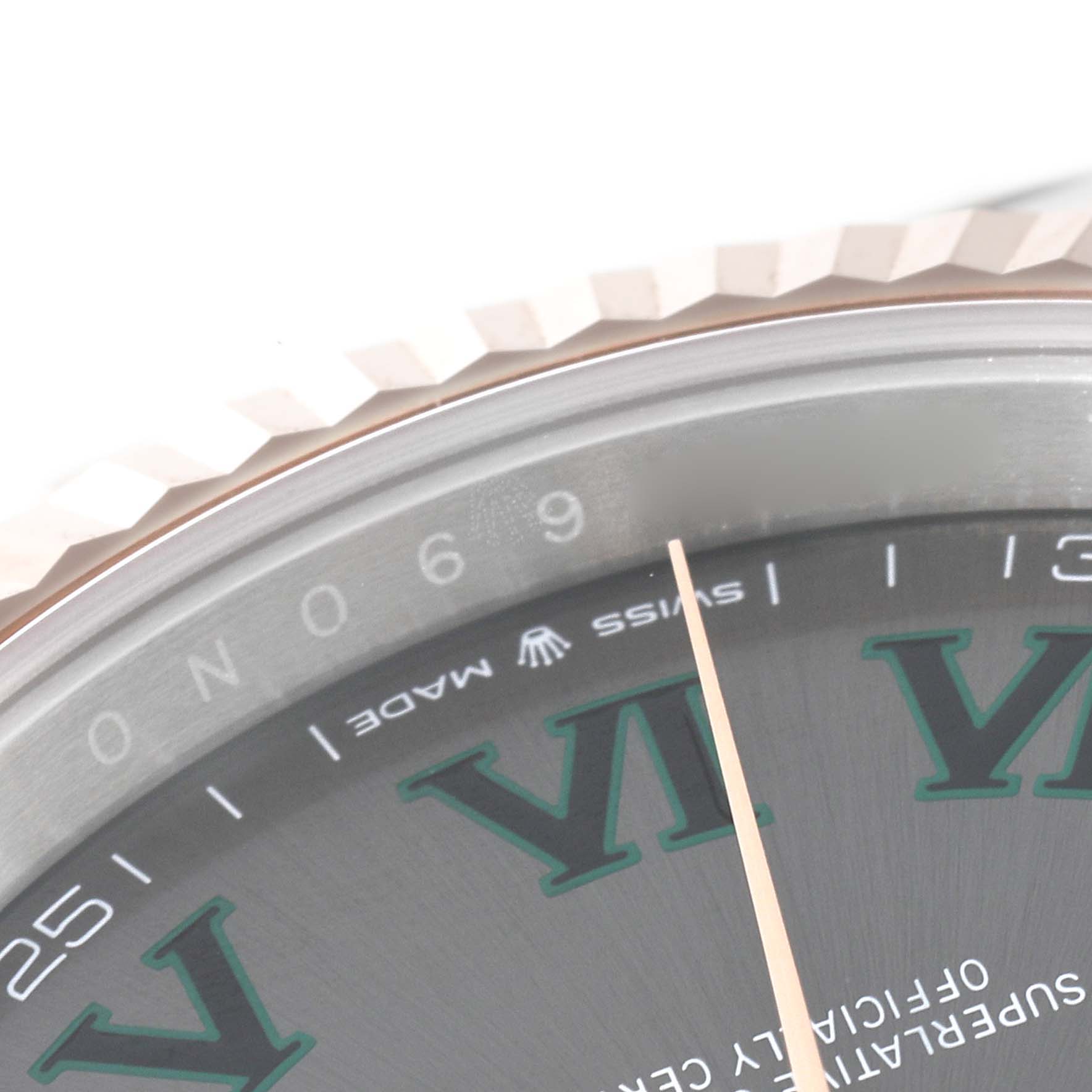 This close-up image of the Rolex Datejust 41 126331 Men's Steel and Gold (two tone) Grey Dial 126331 Men's Steel and Gold (two tone) Grey Dial shows the bezel, partial dial, and the "SWISS MADE" text.