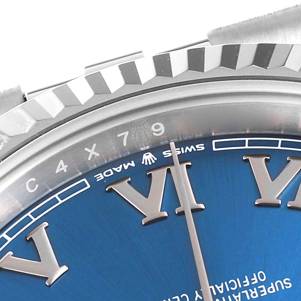 This image shows a close-up of the bezel and part of the dial of a Rolex Datejust 41 126334 Men
s Stainless Steel Blue Dial 126334 Men
s Stainless Steel Blue Dial watch, displaying Roman numerals and the "Swiss Made" label.