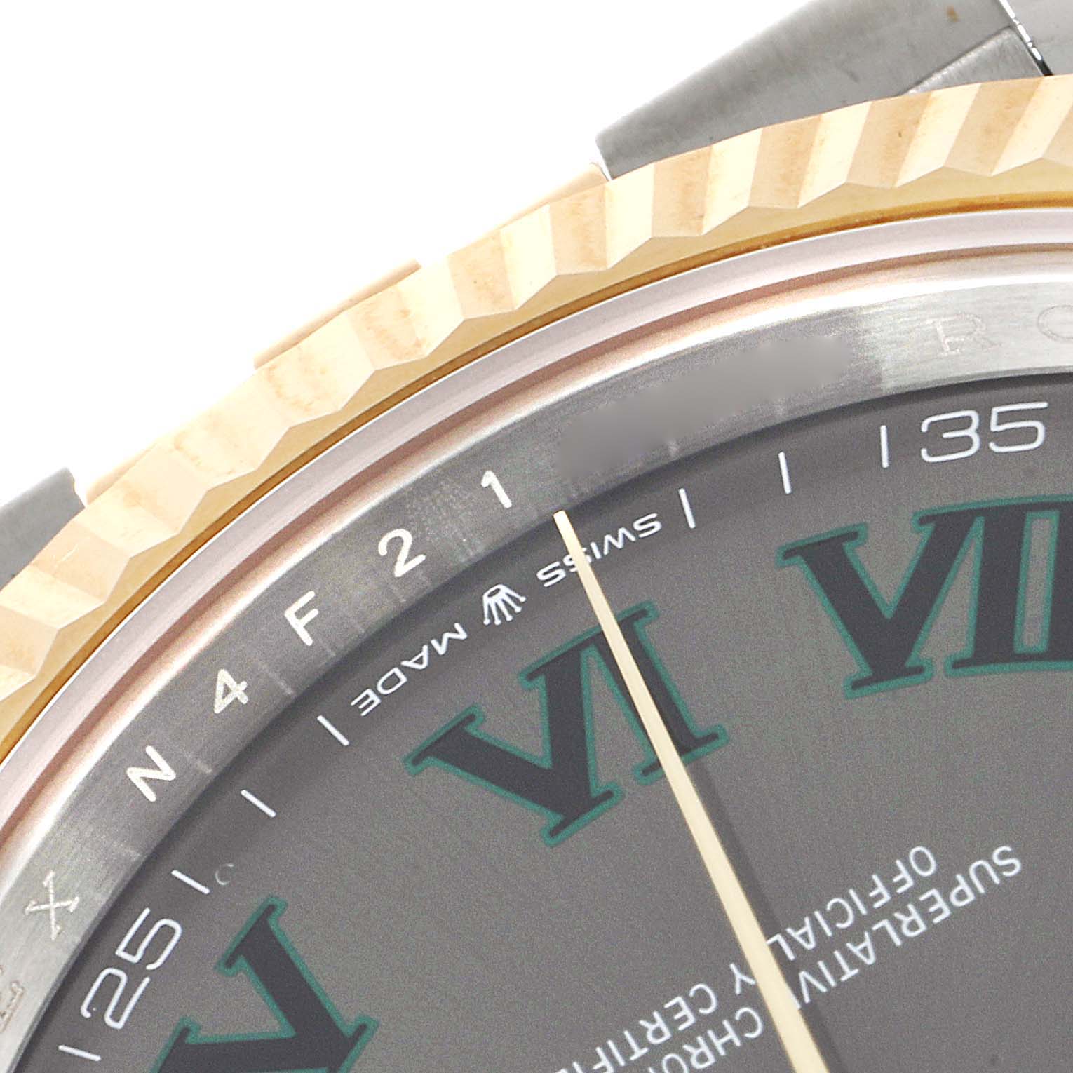 This close-up angle of the Rolex Datejust 41 126333 Men's Steel and Gold (two tone) Grey Dial 126333 Men's Steel and Gold (two tone) Grey Dial model highlights the bezel, part of the dial, and hands.