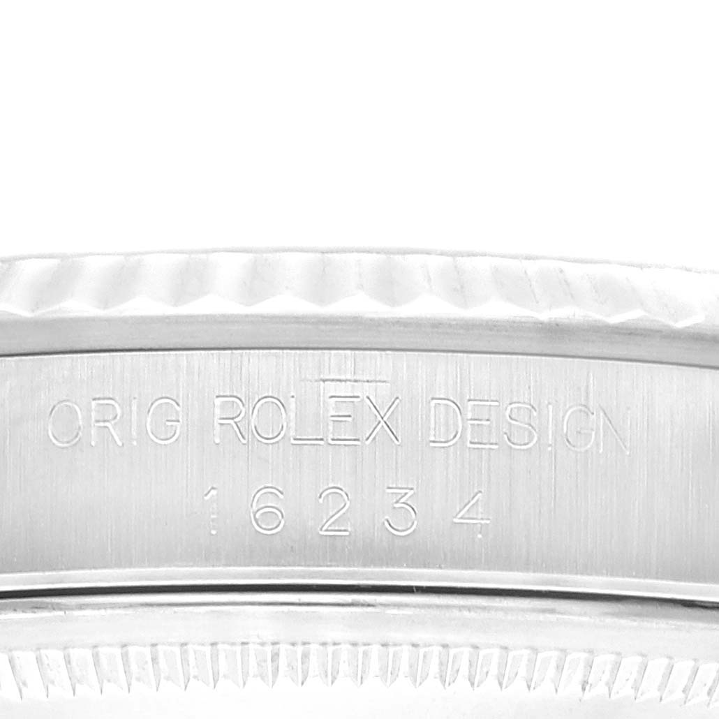 This close-up image shows the side engraving and the fluted bezel of the Rolex Datejust 16234 Men's Stainless Steel Blue Dial 16234 Men's Stainless Steel Blue Dial watch.
