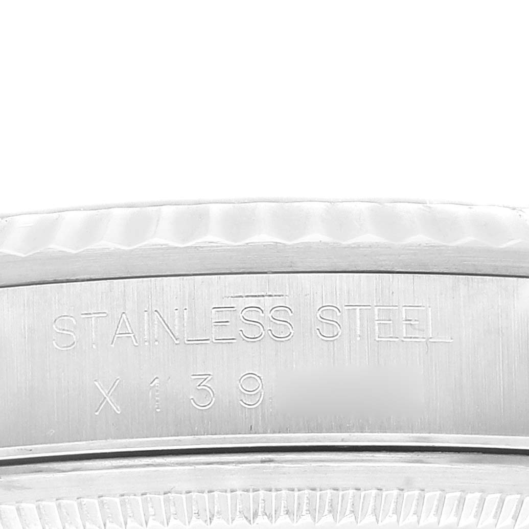 This close-up shows the stainless steel casing of a Rolex Datejust 16234 Men's Stainless Steel Blue Dial 16234 Men's Stainless Steel Blue Dial watch with engraved serial numbers.