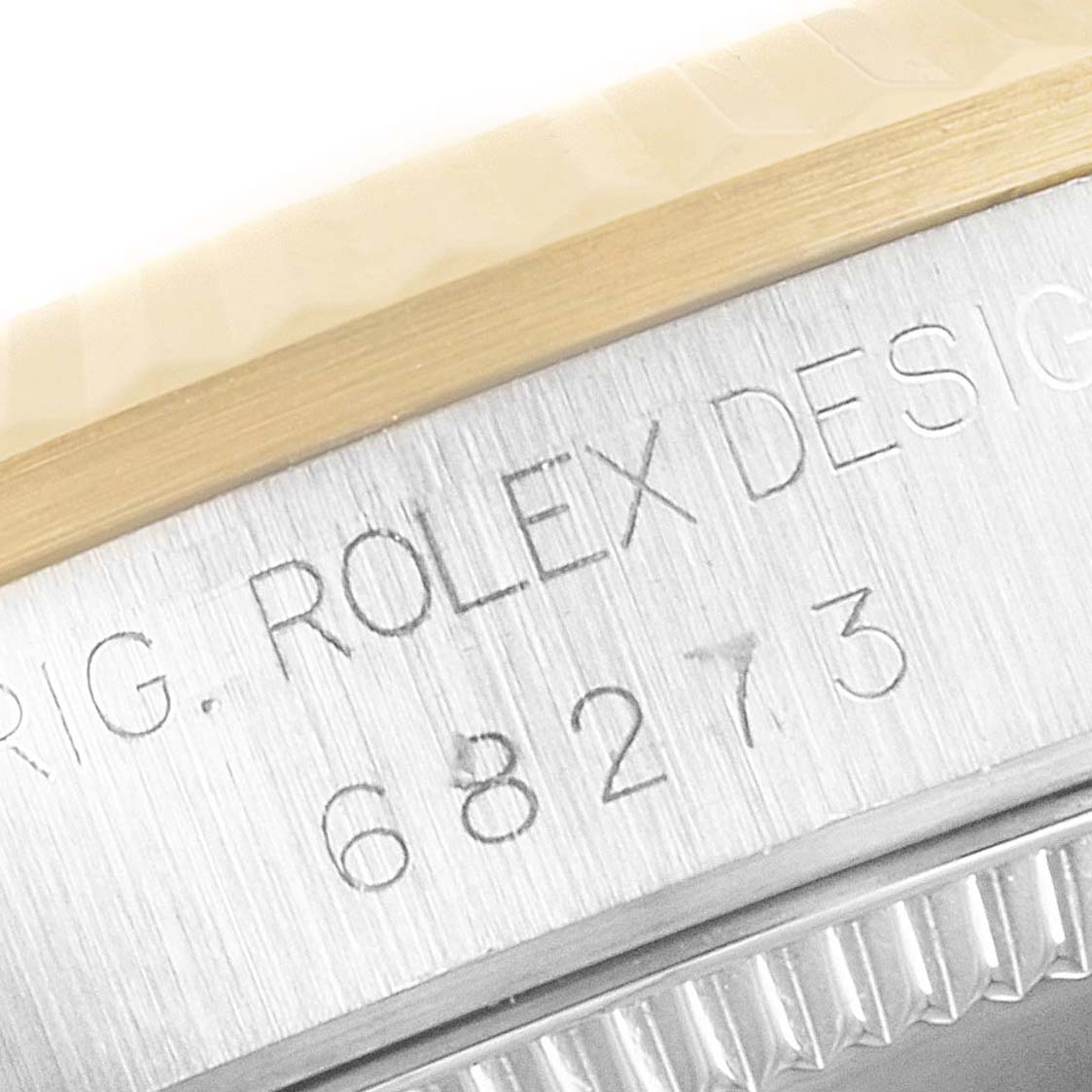 The image shows a close-up of the serial number engraving on the side of the mid-size Rolex watch case.