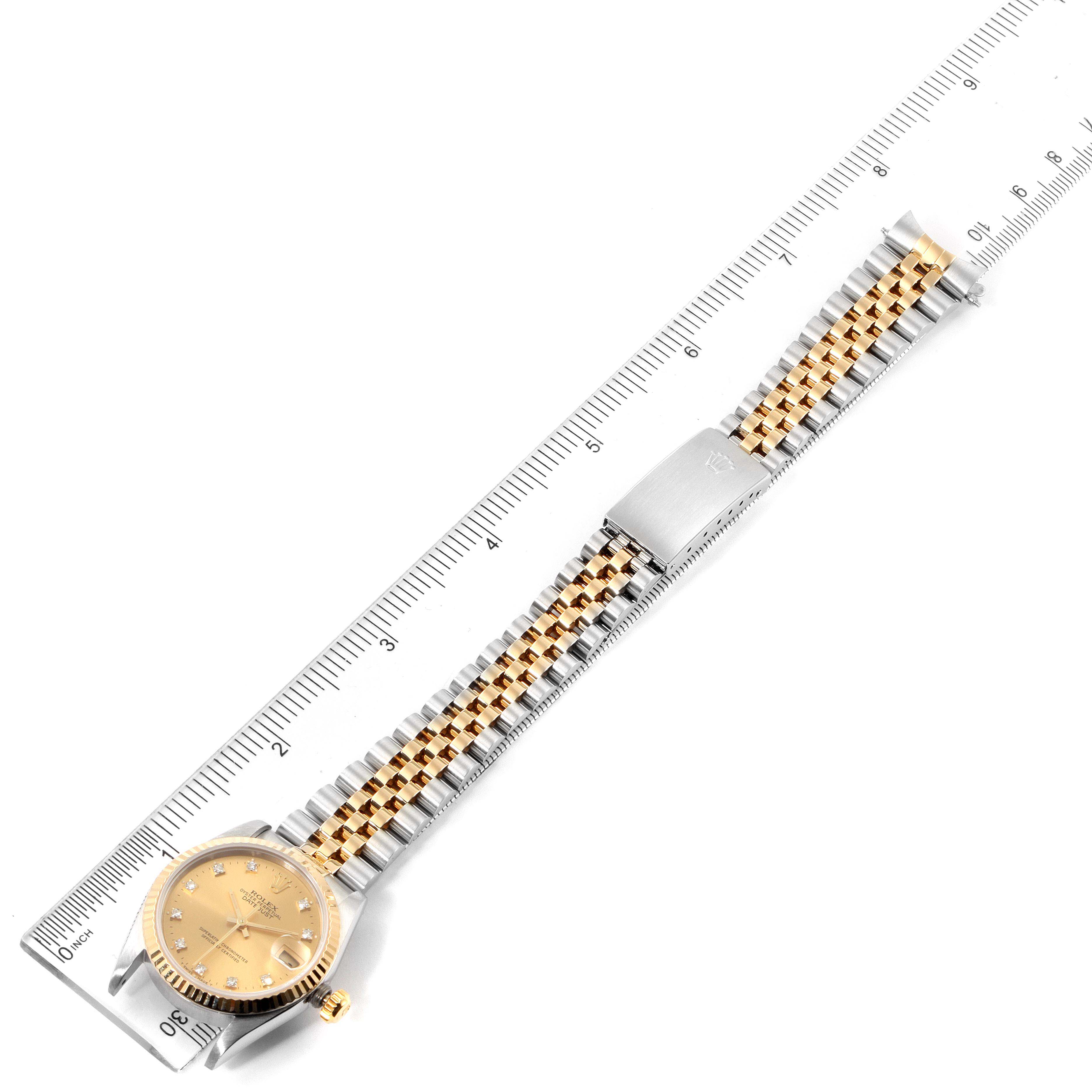 This image shows a Rolex Mid-Size 68273 Women's Steel and Gold (two tone) Champagne Dial 68273 Women's Steel and Gold (two tone) Champagne Dial watch in a top-down view, aligned with a ruler.