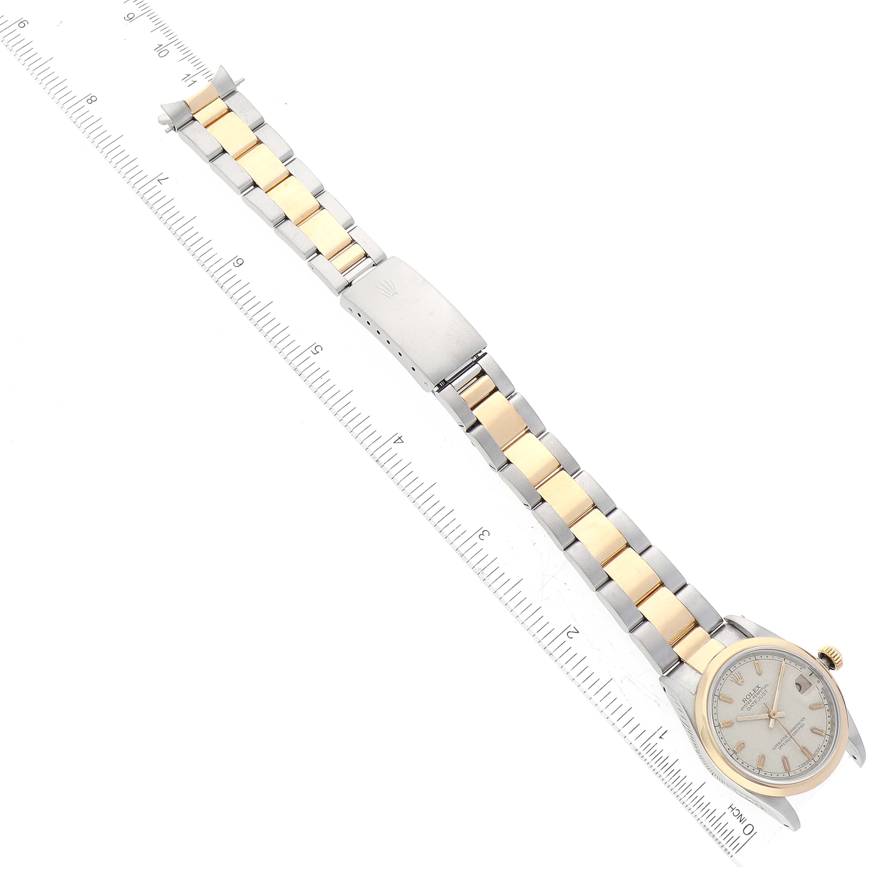 This image shows a Rolex Mid-Size 68243 Women's Steel and Gold (two tone) Beige Dial 68243 Women's Steel and Gold (two tone) Beige Dial model watch with a gold and silver bracelet, displayed next to a ruler.