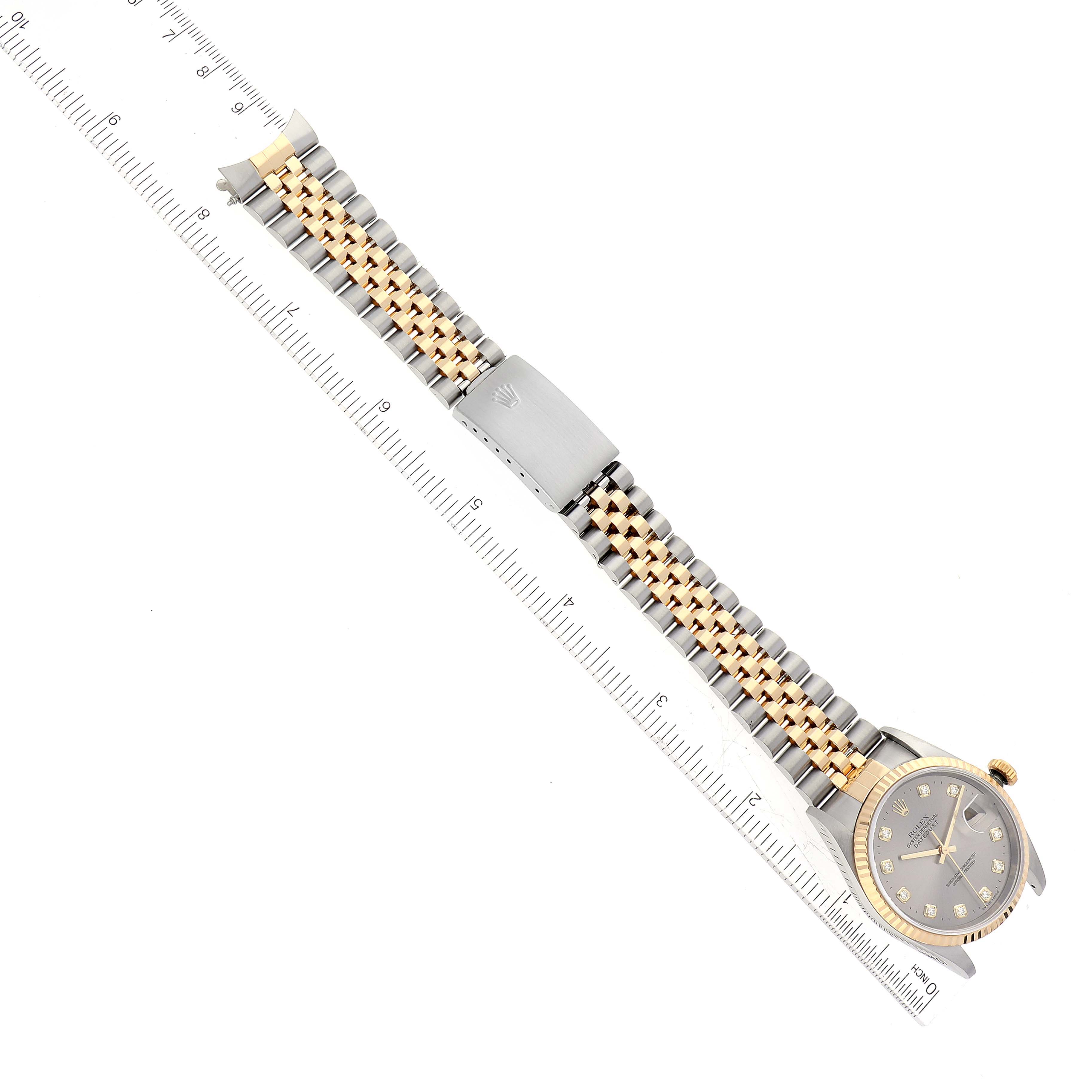 The image shows a Rolex Datejust 16233 Men's Steel and Gold (two tone) Grey Dial 16233 Men's Steel and Gold (two tone) Grey Dial watch laid flat, with both the dial and full strap visible, alongside a ruler for scale.
