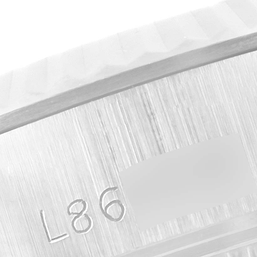 This close-up shows the side of the casing of a Rolex Datejust 69174 Women's Stainless Steel Black Dial 69174 Women's Stainless Steel Black Dial watch, featuring its serial number engraving.