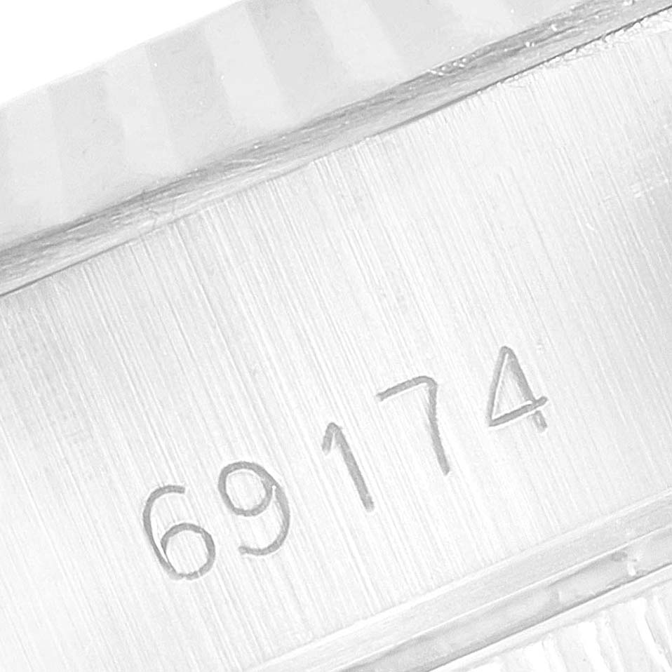 This image shows the serial number engraved on the side case of a Rolex Datejust 69174 Women's Stainless Steel Black Dial 69174 Women's Stainless Steel Black Dial watch.