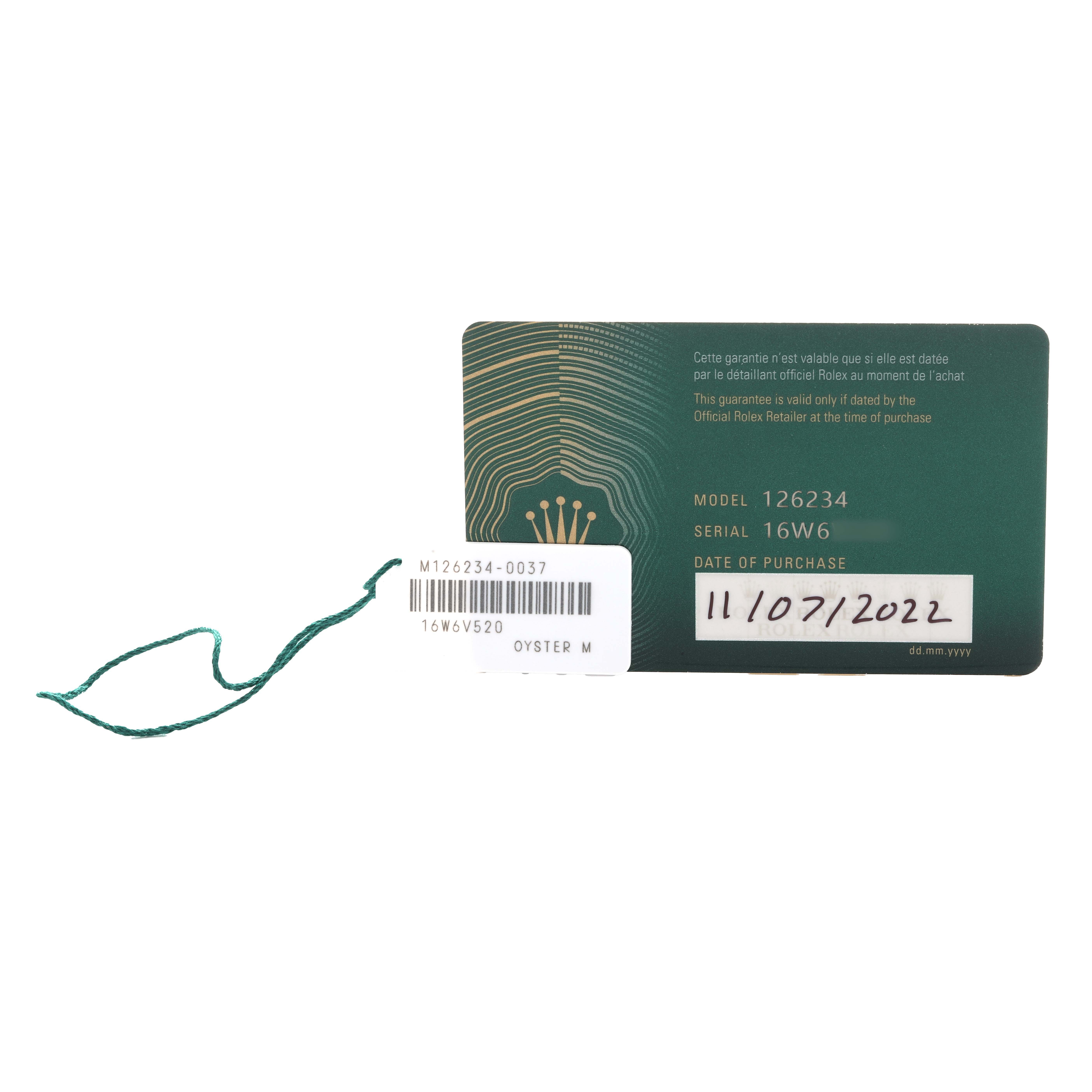 The image shows a Rolex Datejust 126234 Men's Stainless Steel Blue Dial warranty card and tag, displaying model and serial numbers.