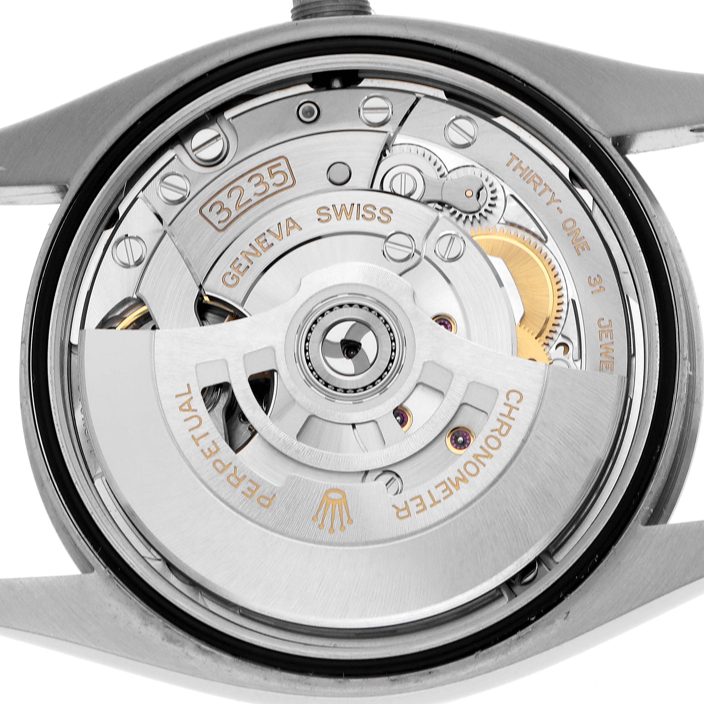 The image shows a close-up view of the Rolex Datejust 126234 Men's Stainless Steel Blue Dial's movement, showcasing the intricate inner mechanisms.