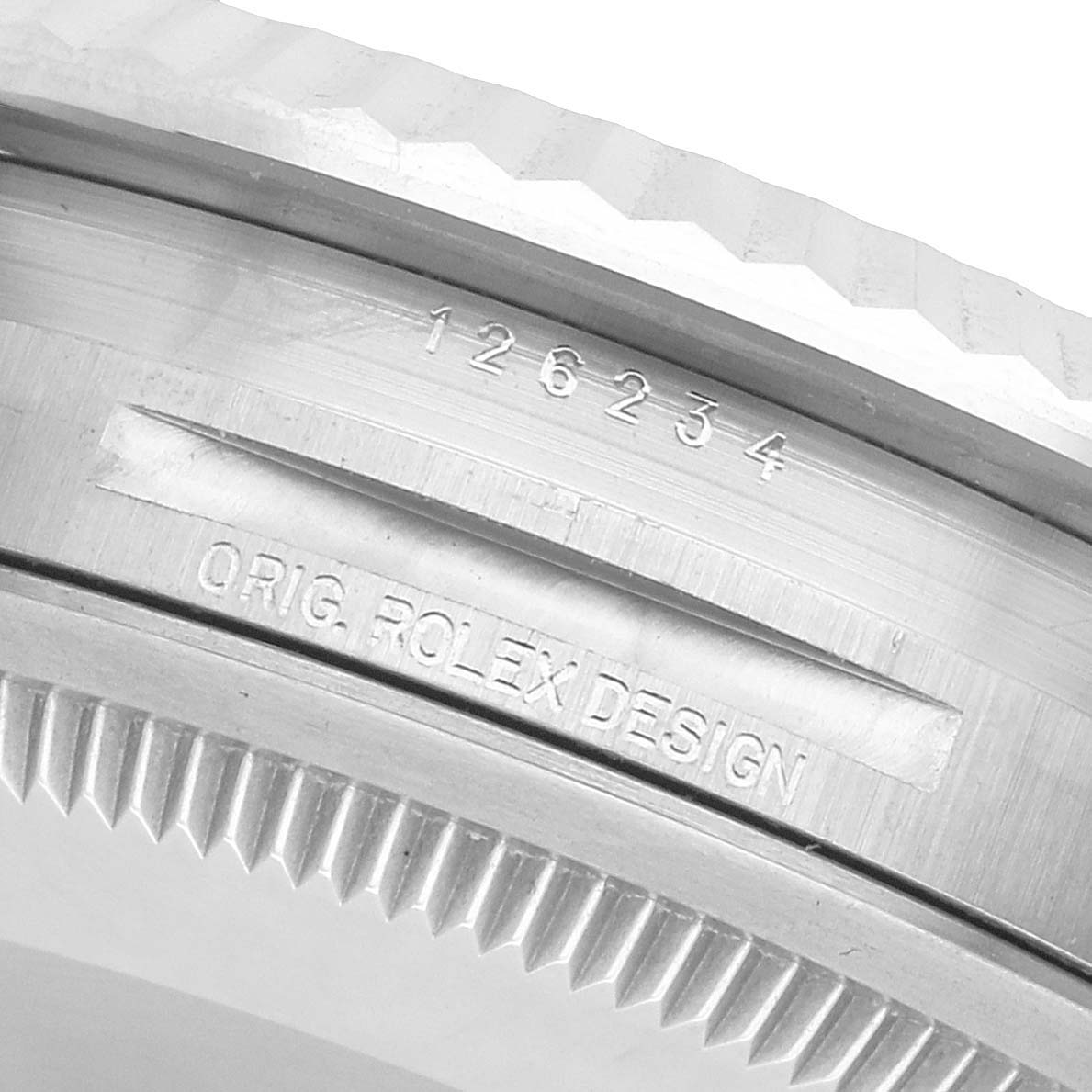 The image shows a close-up of the case edge of a Rolex Datejust 126234 Men's Stainless Steel Blue Dial, highlighting the model number and "ORIG. ROLEX DESIGN" engraving.