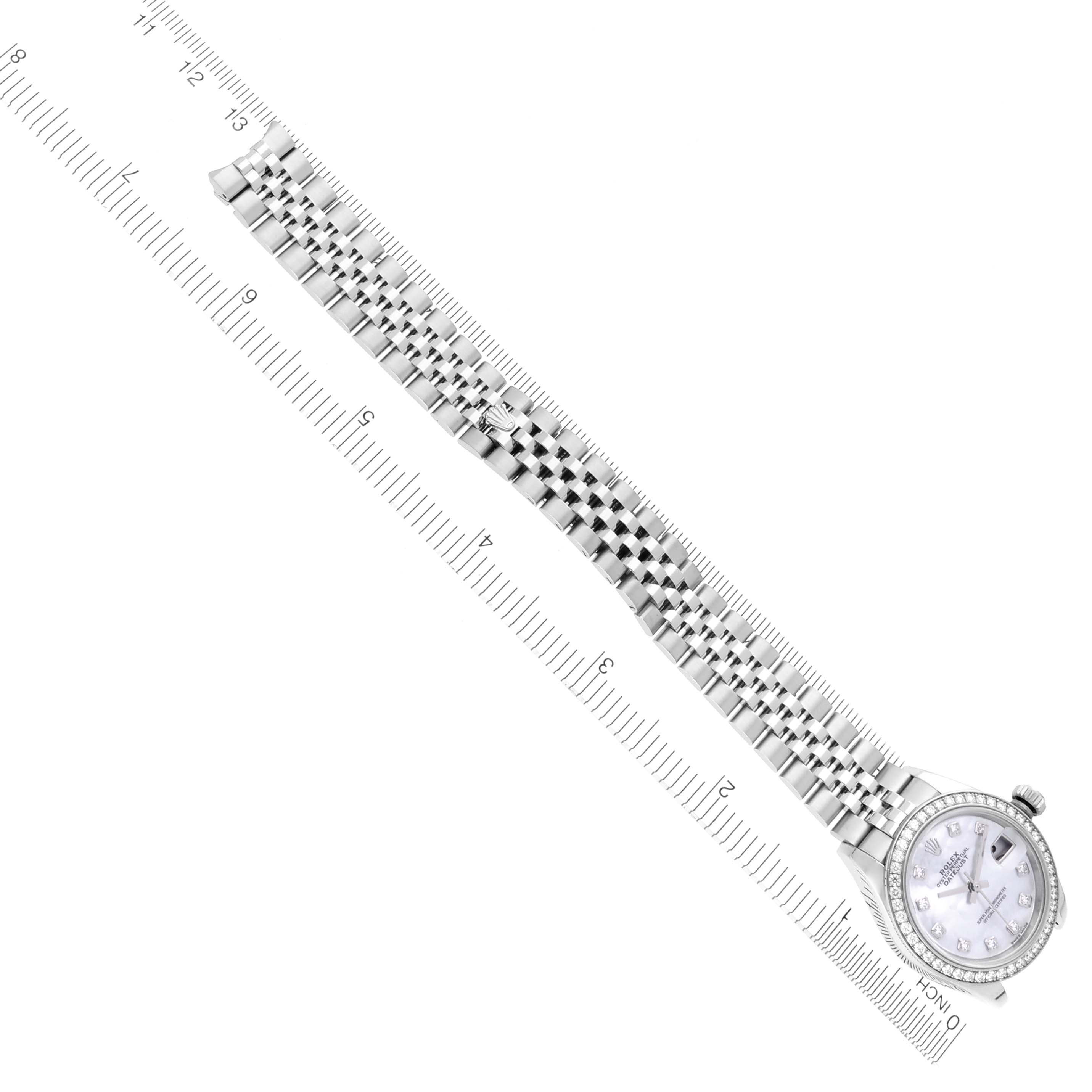 The Rolex Datejust 279384RBR Women's Stainless Steel Mother of Pearl Dial 279384RBR Women's Stainless Steel Mother of Pearl Dial watch is shown at an angle highlighting its face, bezel, and full bracelet alongside a ruler for scale.
