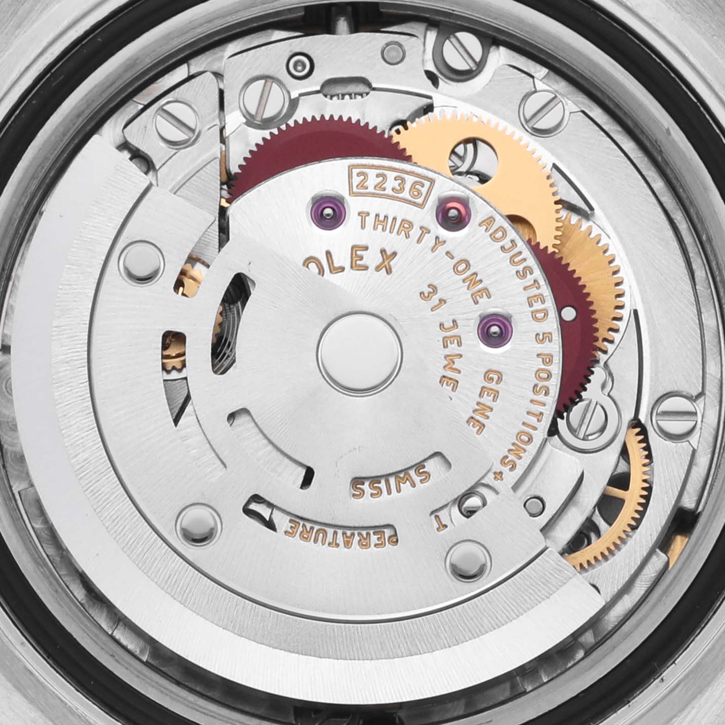 The image shows a close-up of the movement mechanism of a Rolex Datejust 279384RBR Women's Stainless Steel Mother of Pearl Dial 279384RBR Women's Stainless Steel Mother of Pearl Dial watch, highlighting its intricate gears and engravings.