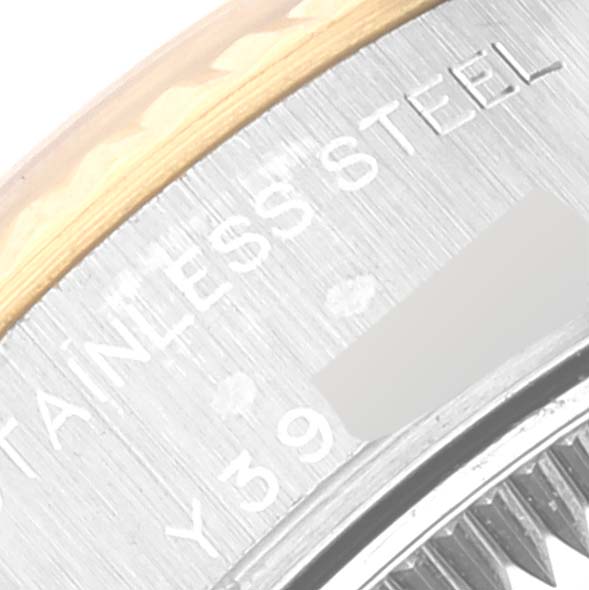 This is a close-up of the side of a Rolex Datejust 79173 Women's Steel and Gold (two tone) Champagne Dial 79173 Women's Steel and Gold (two tone) Champagne Dial's stainless steel casing, showing partial engravings.