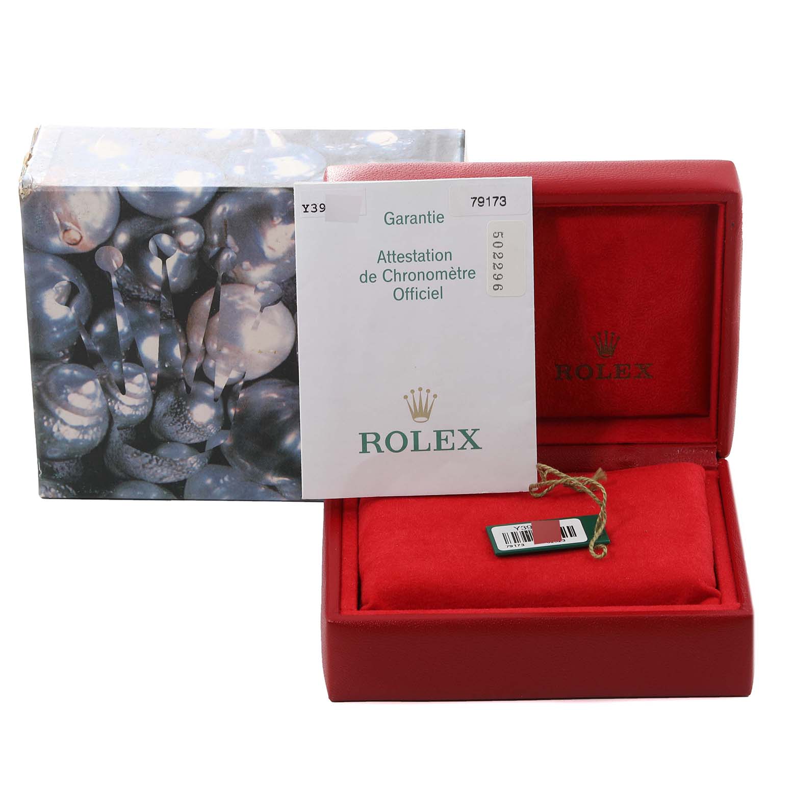 The image shows a Rolex Datejust 79173 Women's Steel and Gold (two tone) Champagne Dial 79173 Women's Steel and Gold (two tone) Champagne Dial box, guarantee paperwork, and a red watch cushion with a tag.