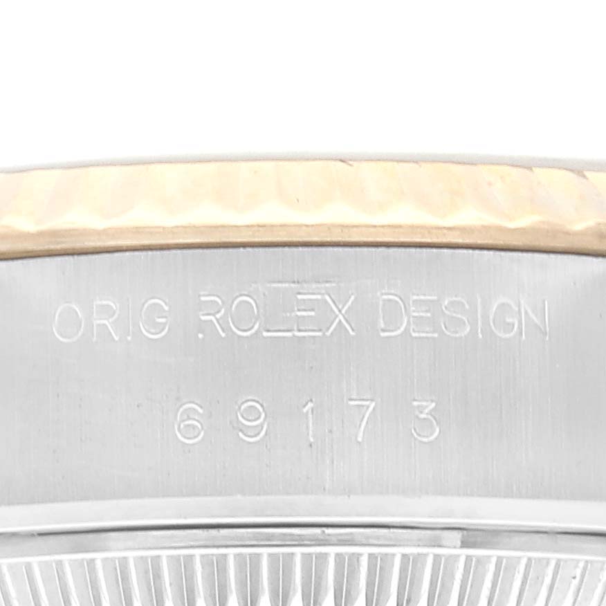 This image shows a close-up of the side of a Rolex Datejust 69173 Women's Steel and Gold (two tone) Champagne Dial 69173 Women's Steel and Gold (two tone) Champagne Dial model watch, focusing on the engraved text and part of the bezel.