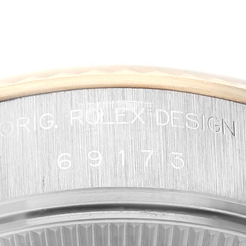 The image shows a close-up of the case side of a Rolex Datejust 69173 Women's Steel and Gold (two tone) Champagne Dial 69173 Women's Steel and Gold (two tone) Champagne Dial, highlighting the engraving on the edge.