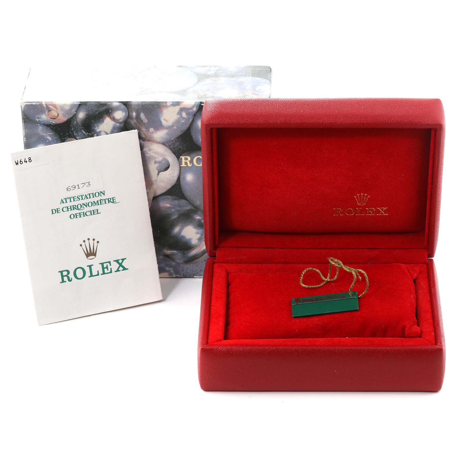 This image shows a Rolex Datejust 69173 Women's Steel and Gold (two tone) Champagne Dial 69173 Women's Steel and Gold (two tone) Champagne Dial watch box, a certificate booklet, and a tag within a red cushiony interior.