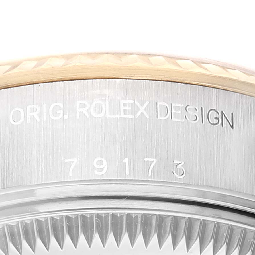 The image shows a close-up of the serial number engraving on the side of a Rolex Datejust 79173 Women's Steel and Gold (two tone) Champagne Dial 79173 Women's Steel and Gold (two tone) Champagne Dial watch case.