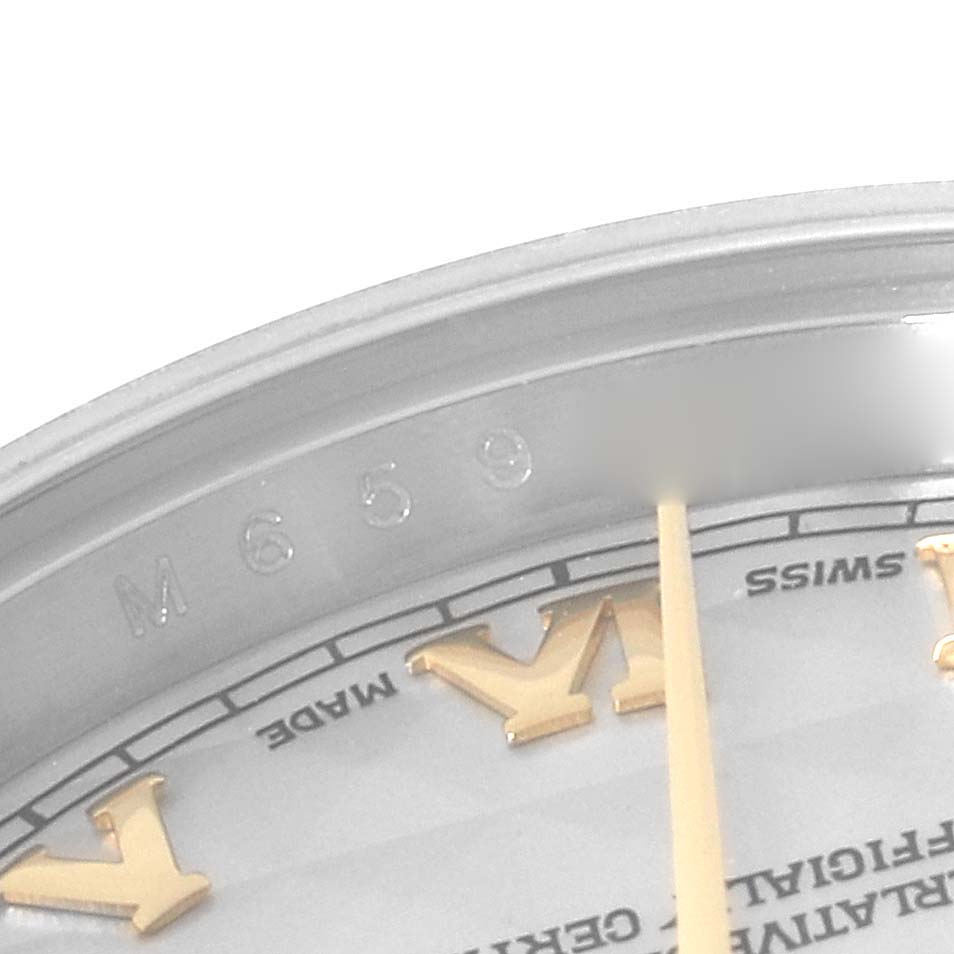 This image shows a close-up of the dial's edge, with Roman numeral hour markers and part of the serial number on a Rolex Datejust 179173 Women's Steel and Gold (two tone) Beige Dial 179173 Women's Steel and Gold (two tone) Beige Dial.