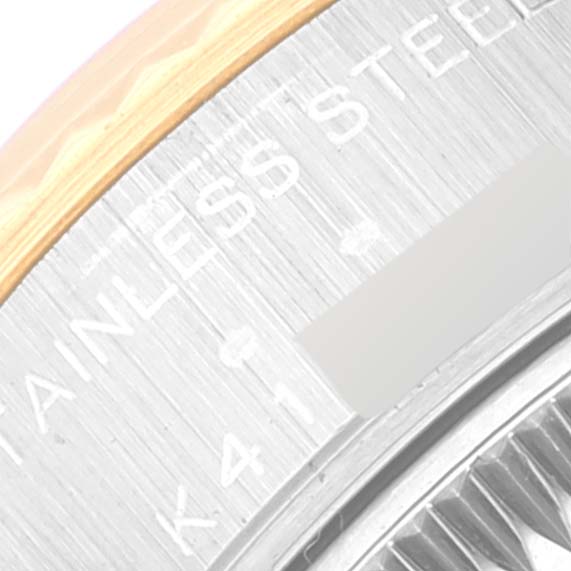 This image shows a close-up of the side and back of the case of a Rolex Datejust 79173 Women's Steel and Gold (two tone) Beige Dial 79173 Women's Steel and Gold (two tone) Beige Dial watch, highlighting the stainless steel and text engravings.