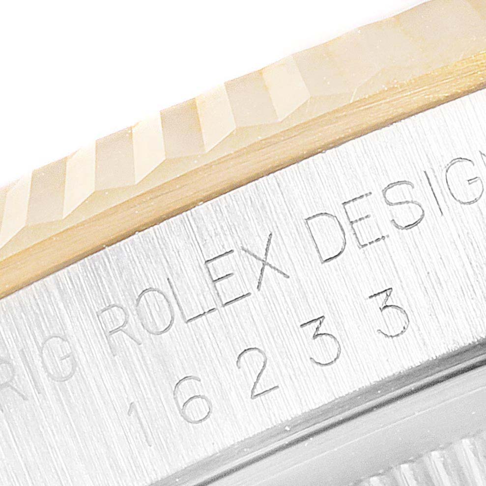 The image shows a close-up of the bezel and case, displaying "Rolex Design" and part of the serial number on a Rolex Datejust 16233 Men
s Steel and Gold (two tone) Mother of Pearl Dial 16233 Men
s Steel and Gold (two tone) Mother of Pearl Dial watch.