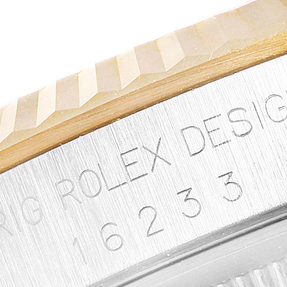 The image shows a close-up angle of the fluted bezel and part of the case with engraved text on a Rolex Datejust 16233 Men
s Stainless Steel Grey Dial 16233 Men
s Stainless Steel Grey Dial watch.