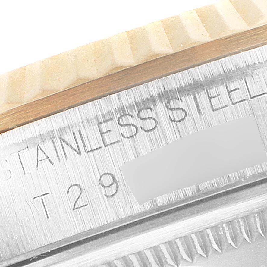 The image shows a close-up angle of the fluted bezel and part of the case with engravings on a Rolex Datejust 16233 Men
s Stainless Steel Grey Dial 16233 Men
s Stainless Steel Grey Dial watch.