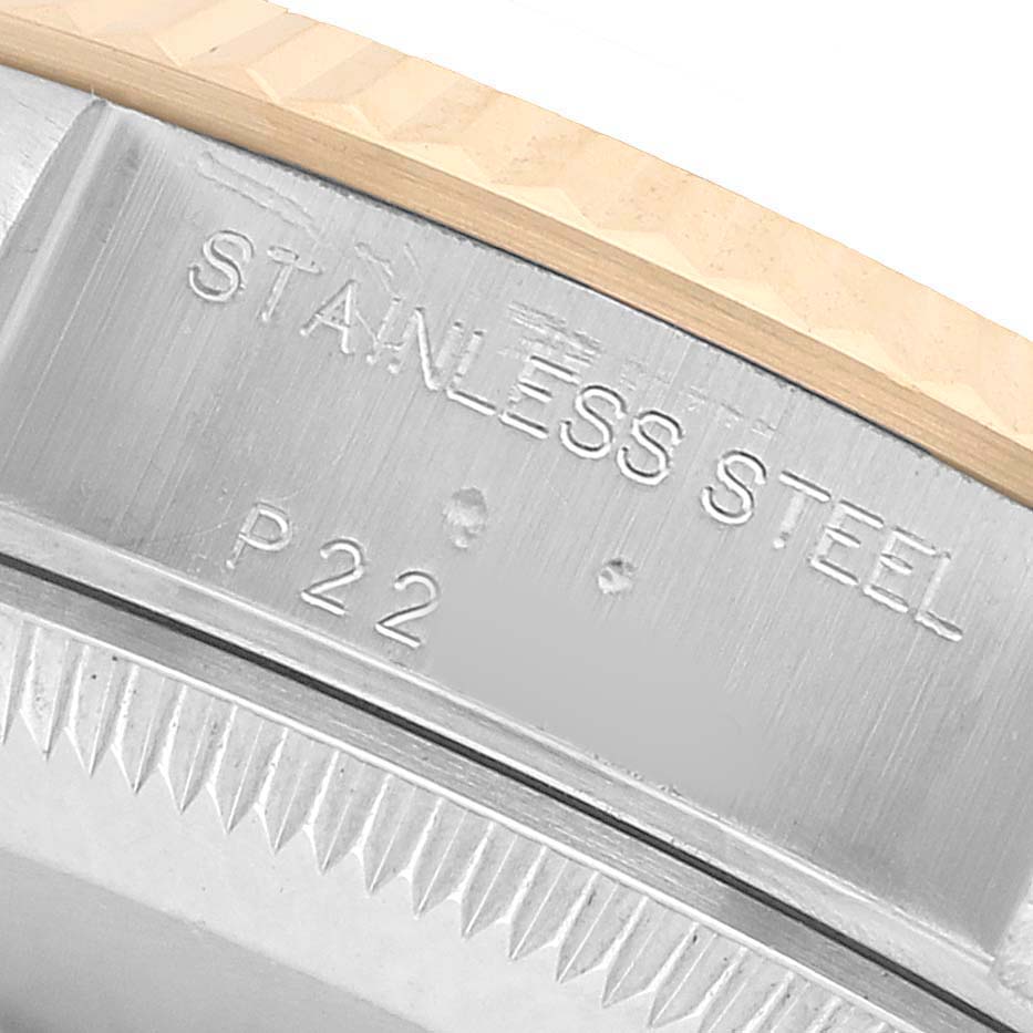 The image shows a close-up of the case side of the Rolex Datejust 79173 Women's Steel and Gold (two tone) White Dial, highlighting the "Stainless Steel" engraving.