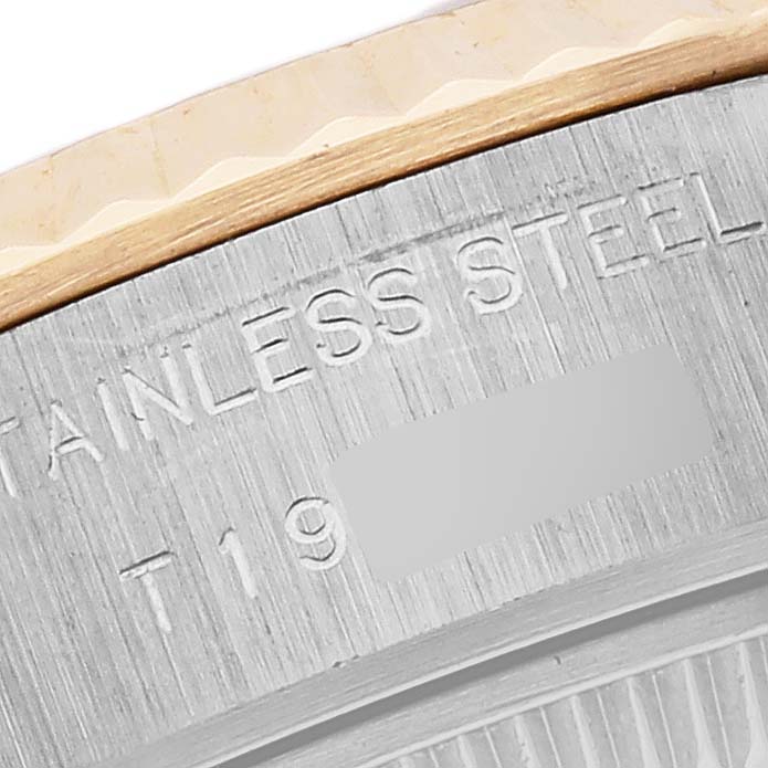 The image shows a close-up of the case back edge of a Rolex Datejust 69173 Women's Steel and Gold (two tone) White Dial 69173 Women's Steel and Gold (two tone) White Dial, highlighting the bezel and stainless steel material.